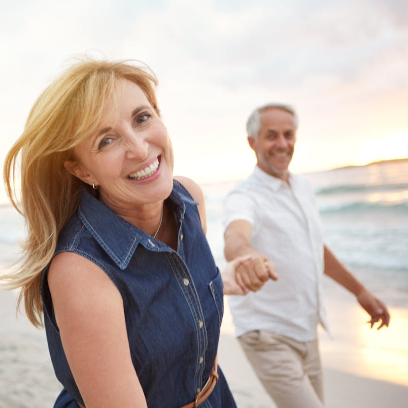 happy middle age couple on the beach