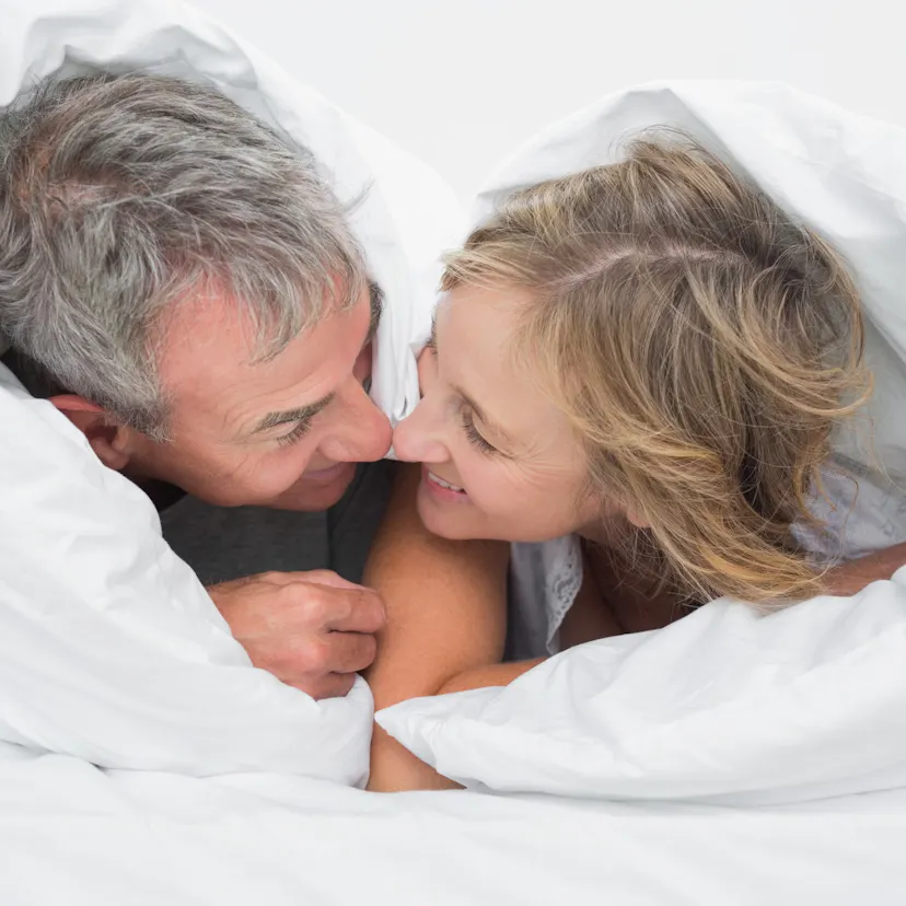 happy middle-aged couple in bed