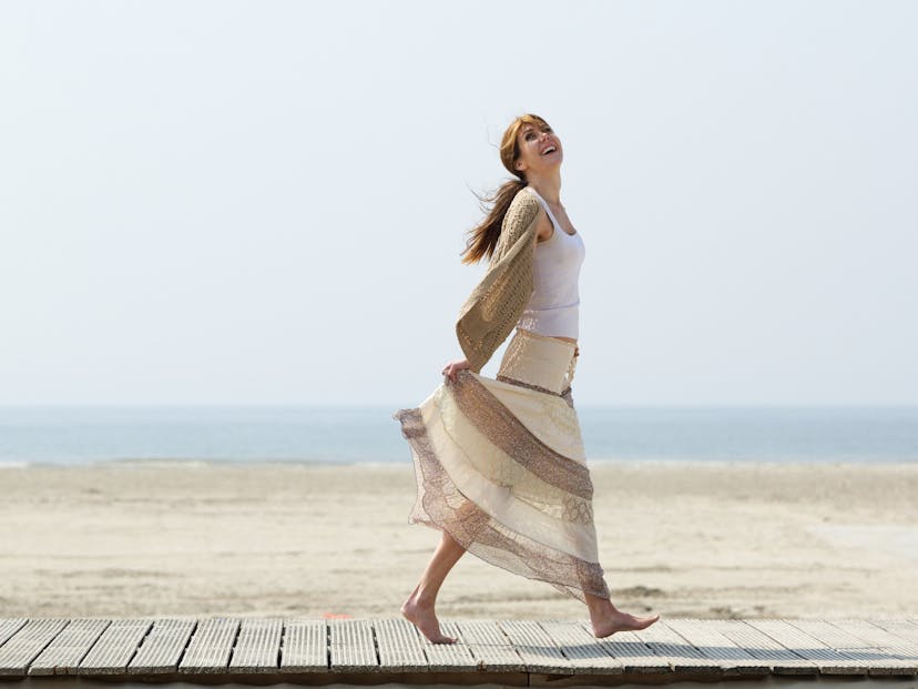 carefree woman walking at the beach