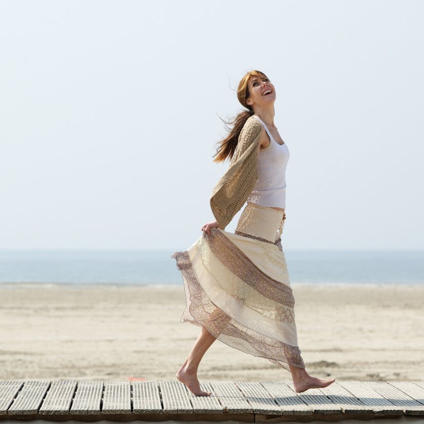 carefree woman walking at the beach