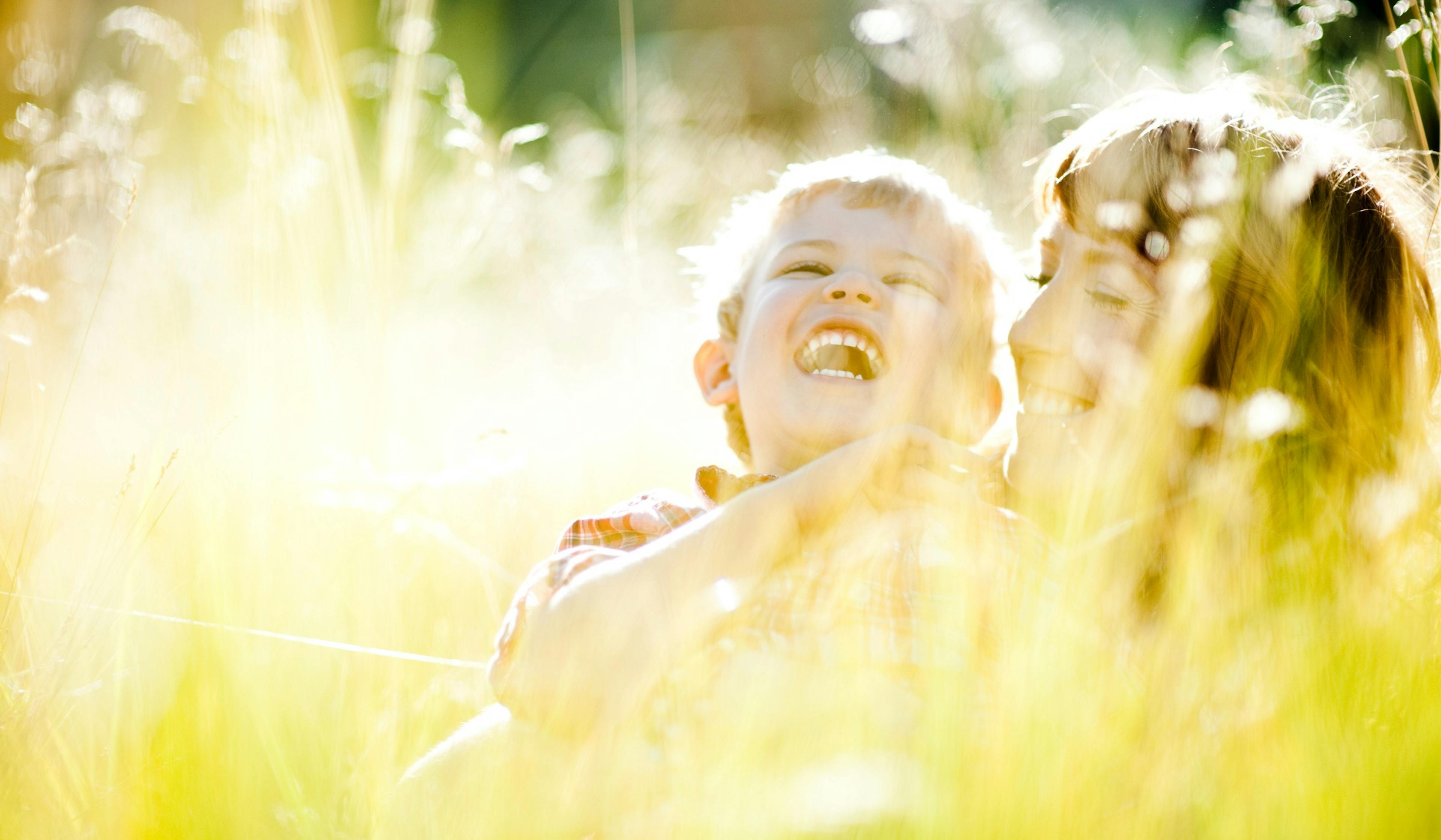 mom and son outside in the grass