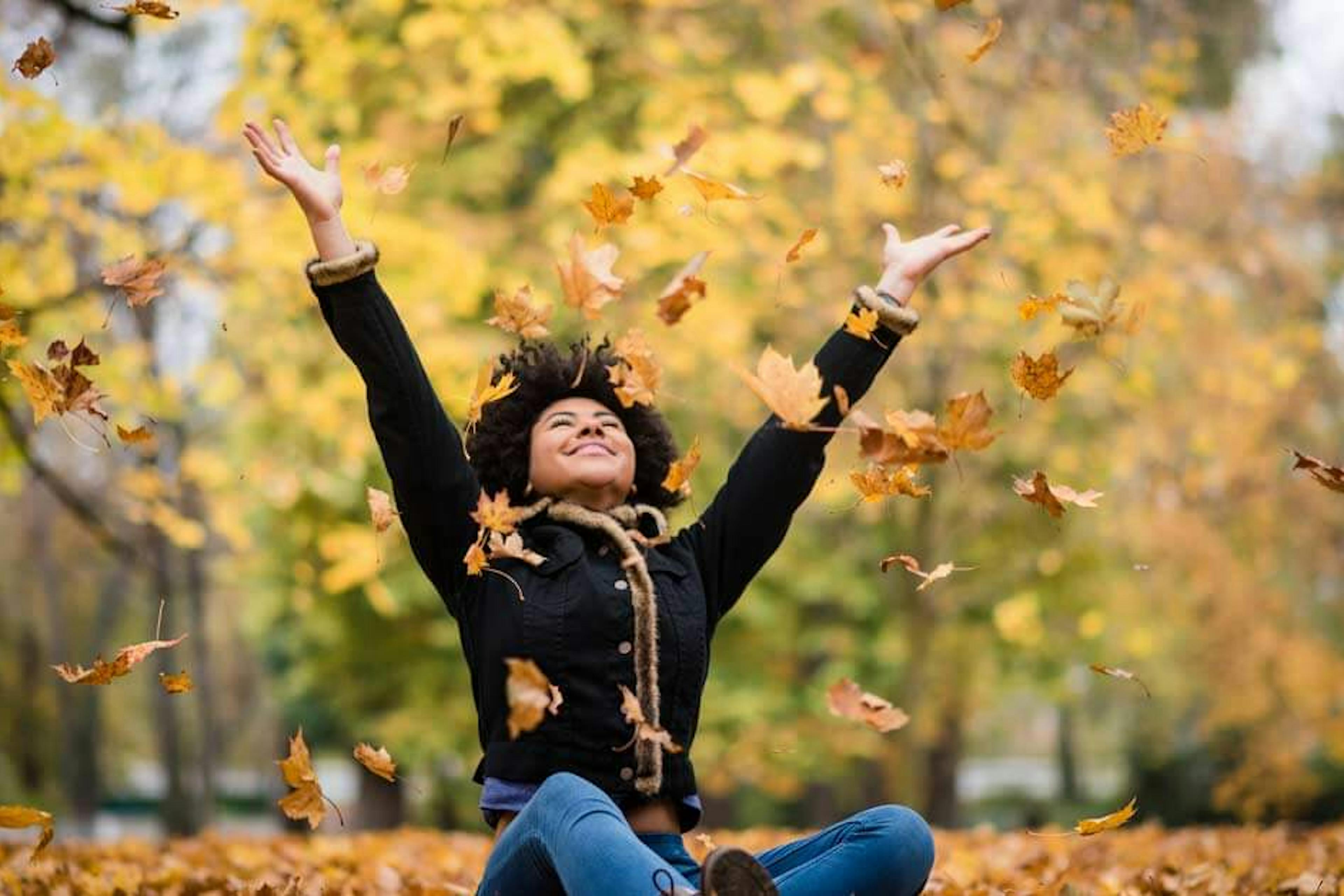 happy woman in the fall leaves