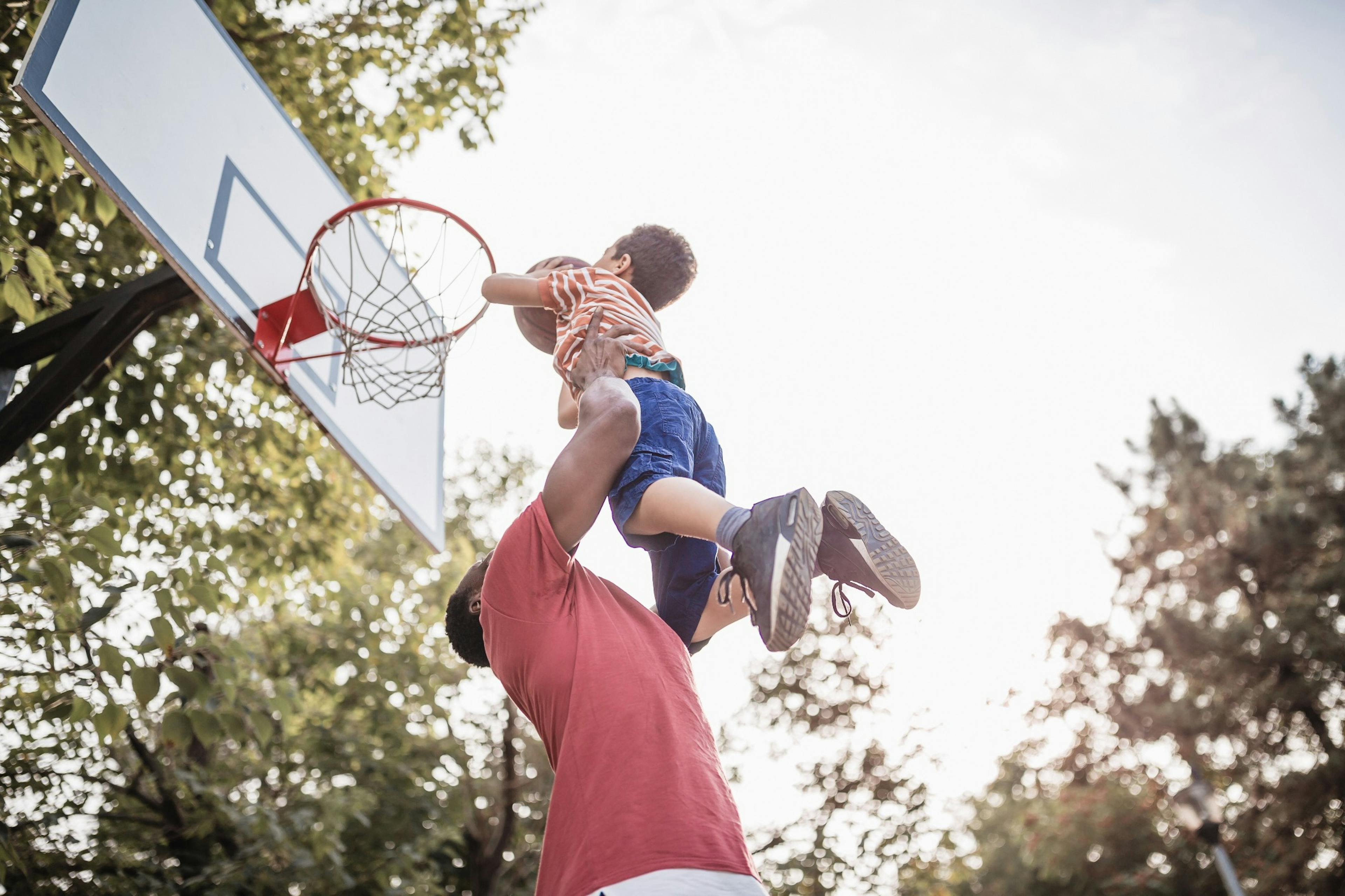 father and son shooting hoops