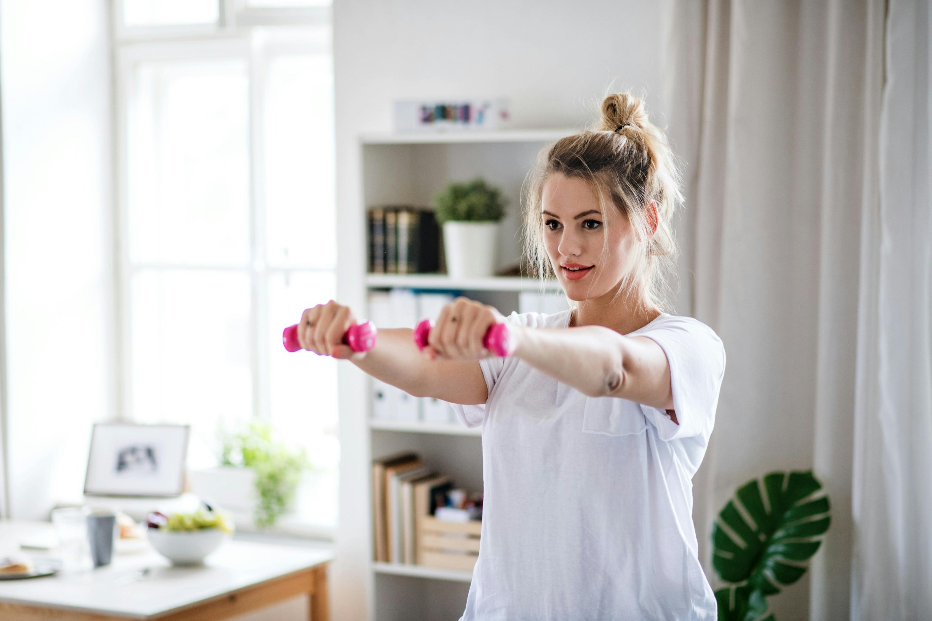 woman lifting weights at home