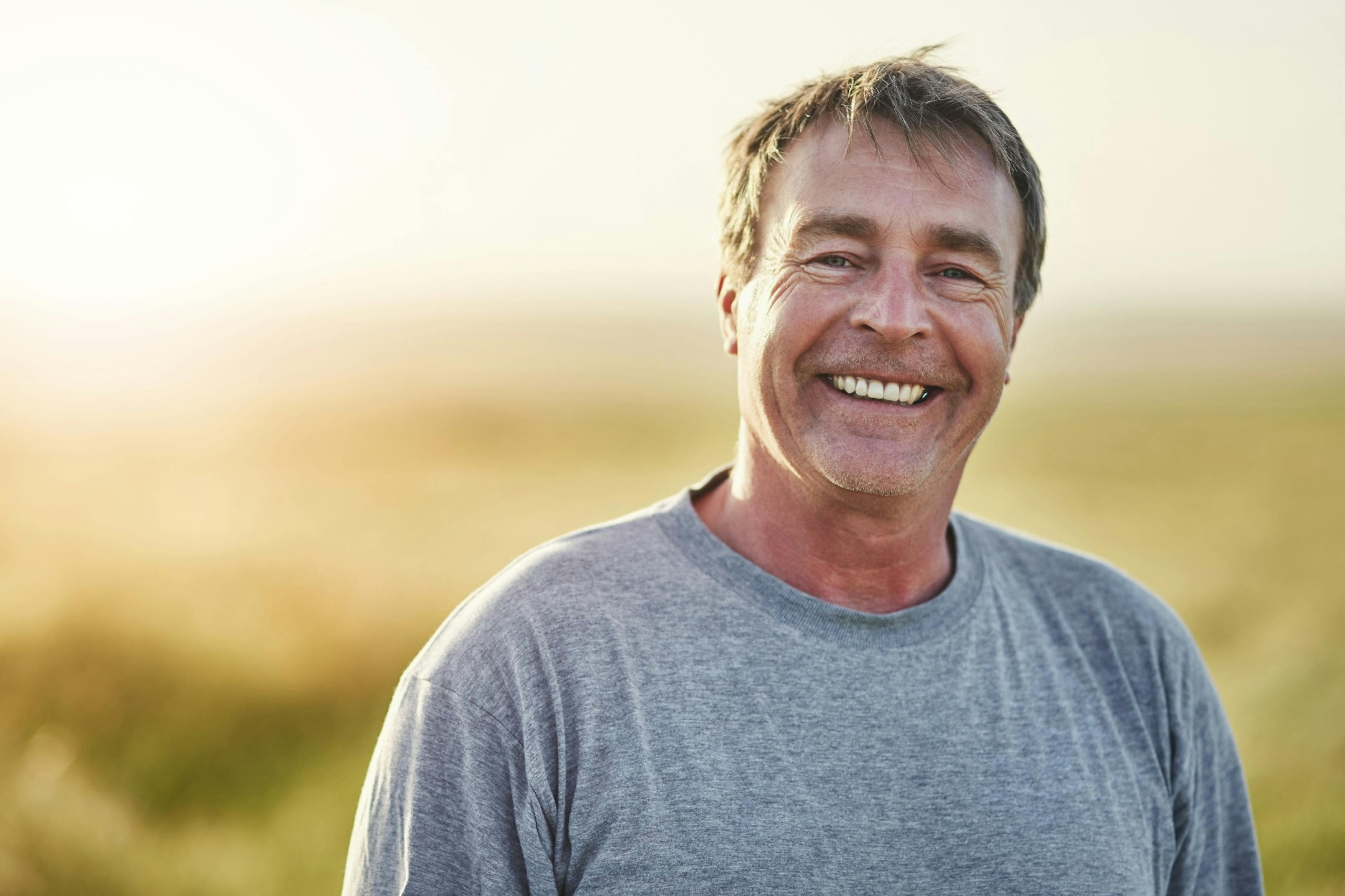 Happy, older man outside in the sun