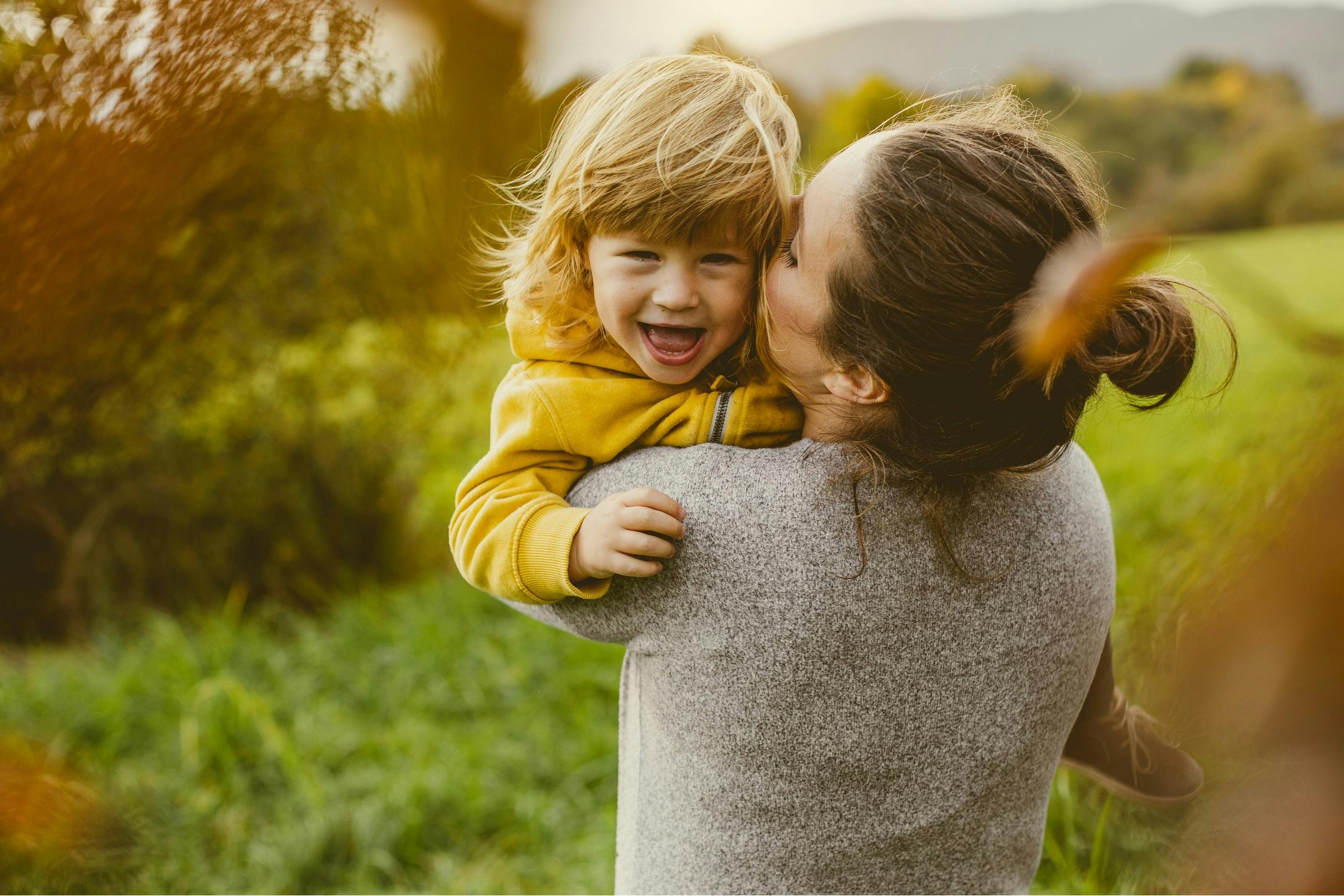 toddler playing with mom outside