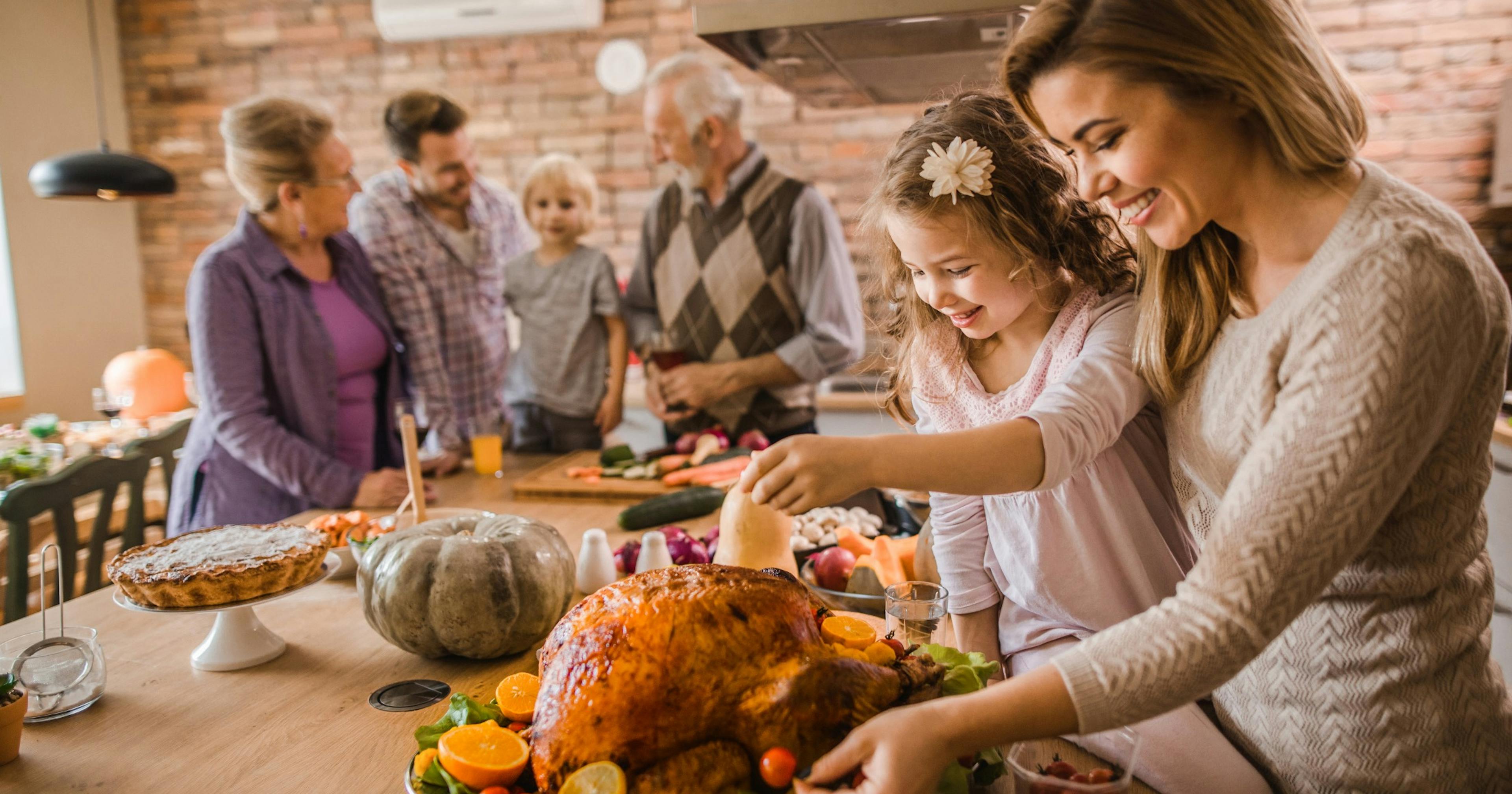 happy mo preparing turkey with daughter