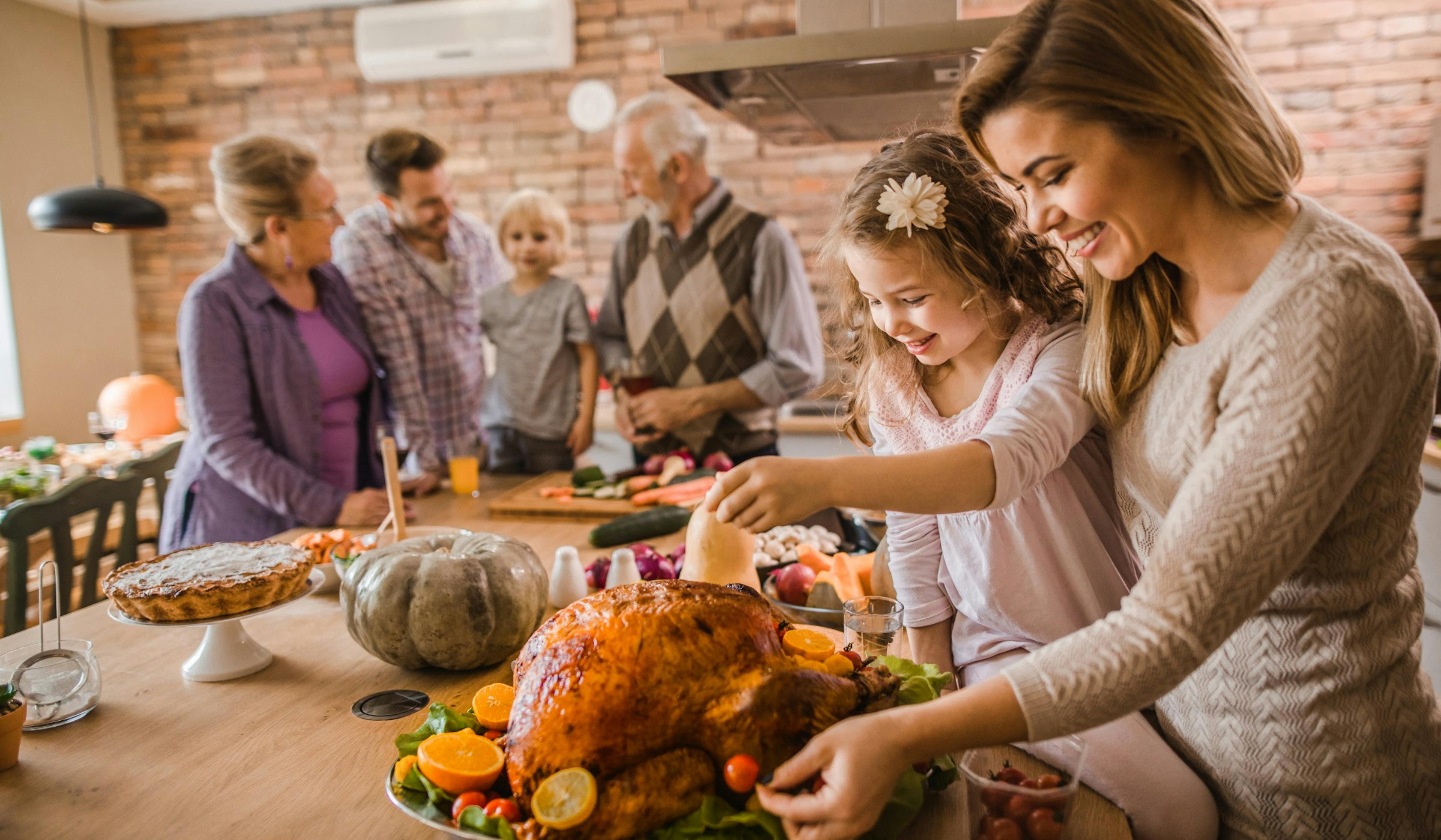 happy mo preparing turkey with daughter