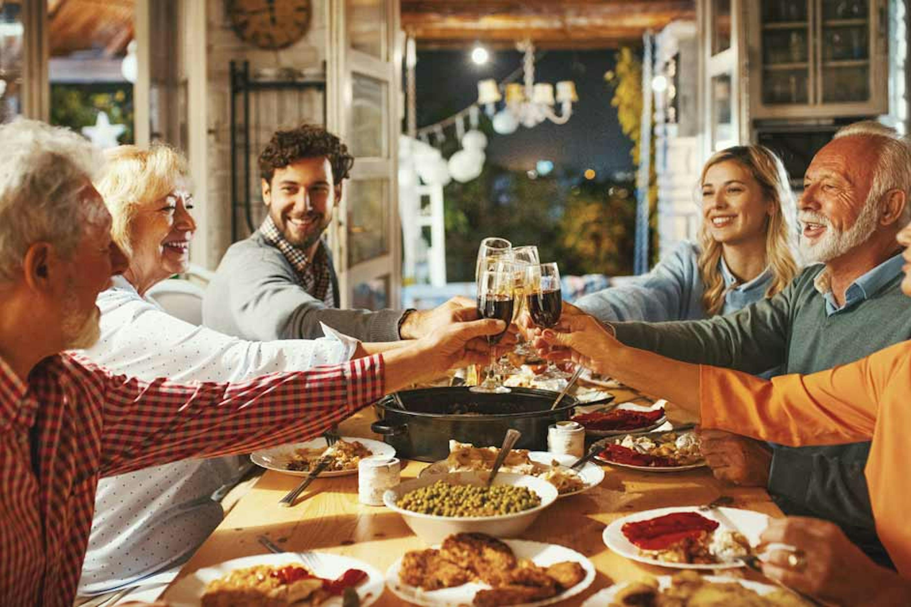 family toasting at dinner