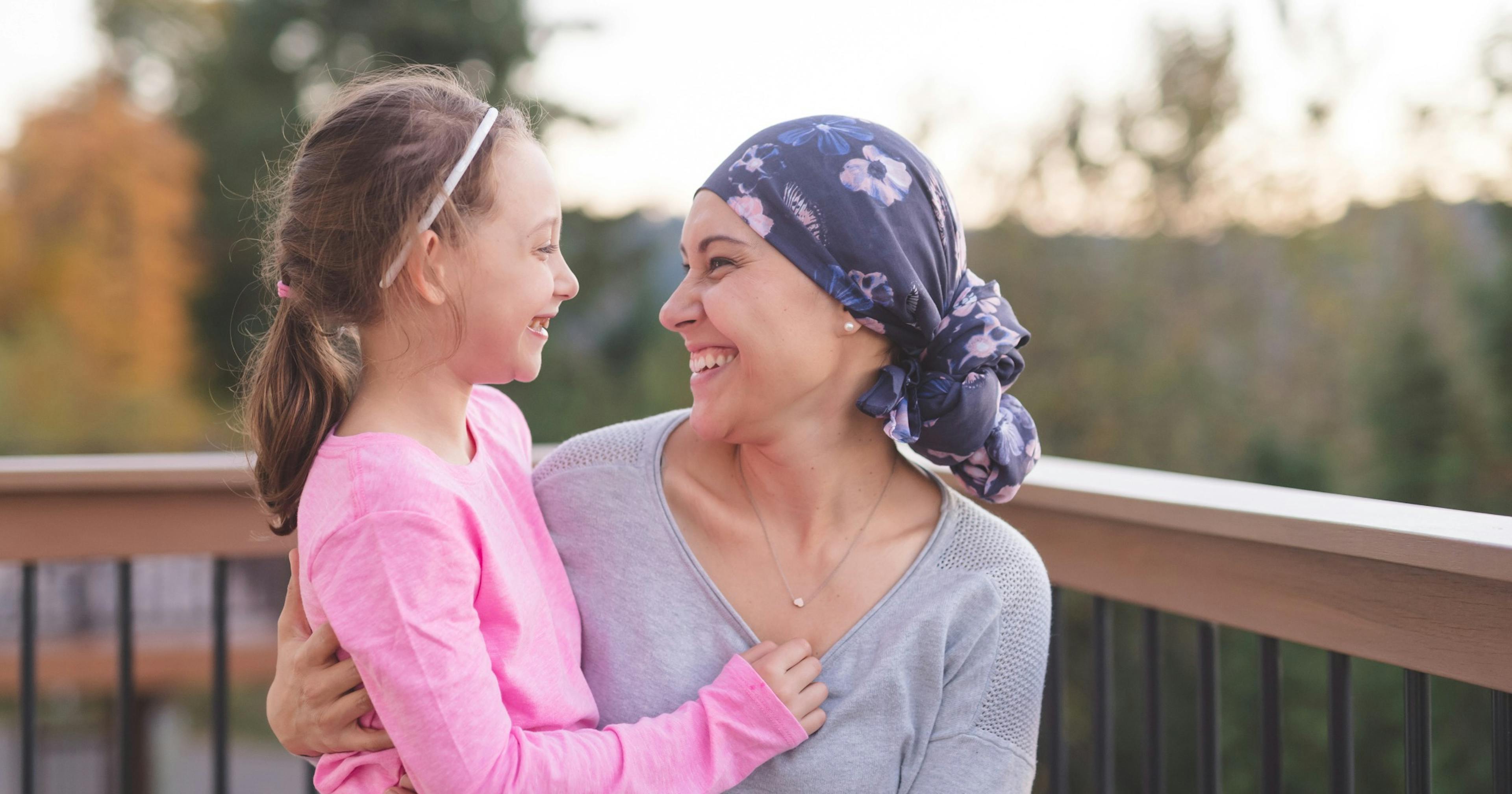 mother with cancer hugging daughter.