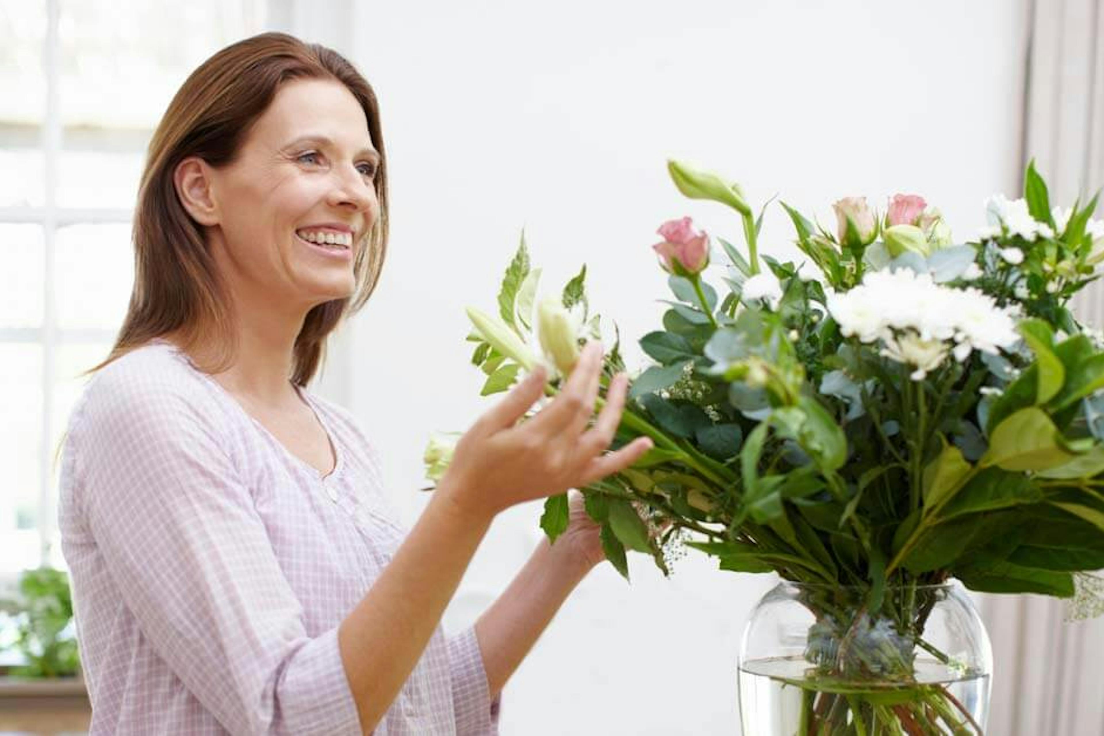 Woman looking at flowers.