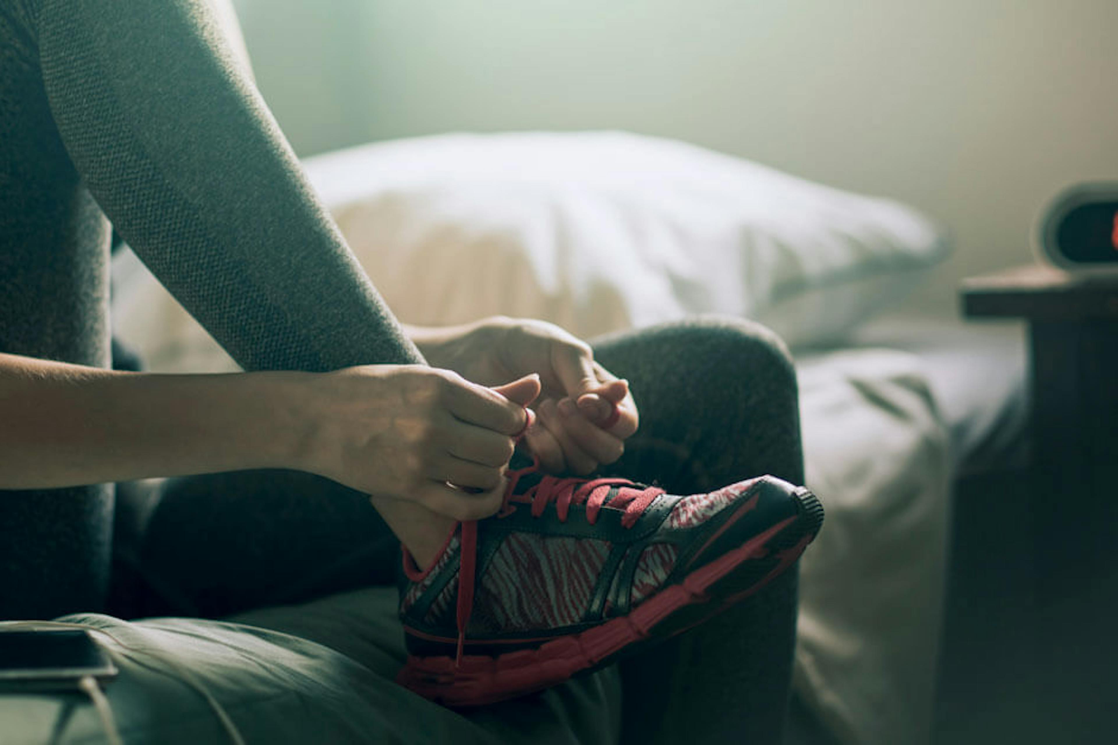 Woman lacing up her tennis shoes