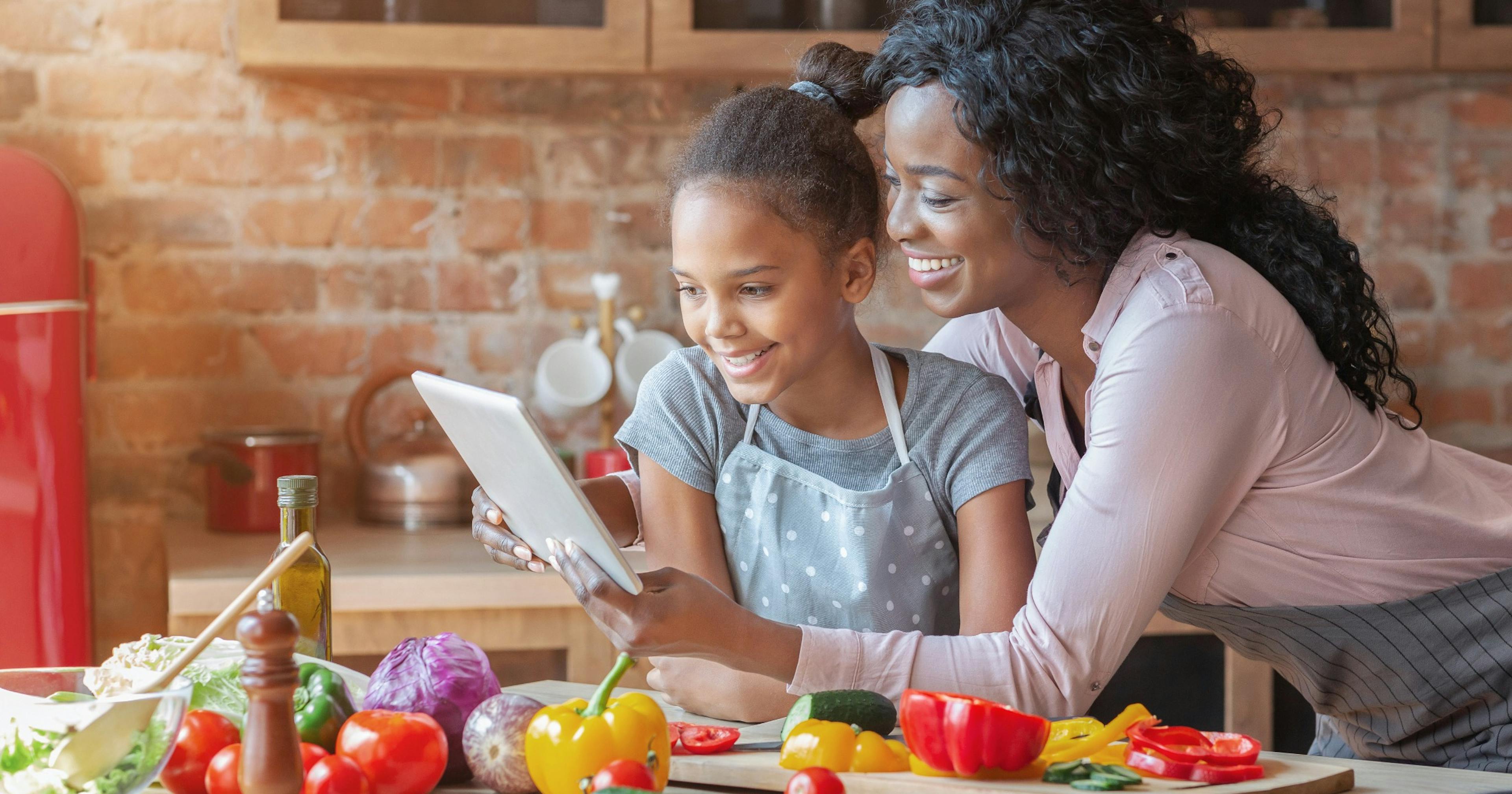 mom and daughter reading a recipe