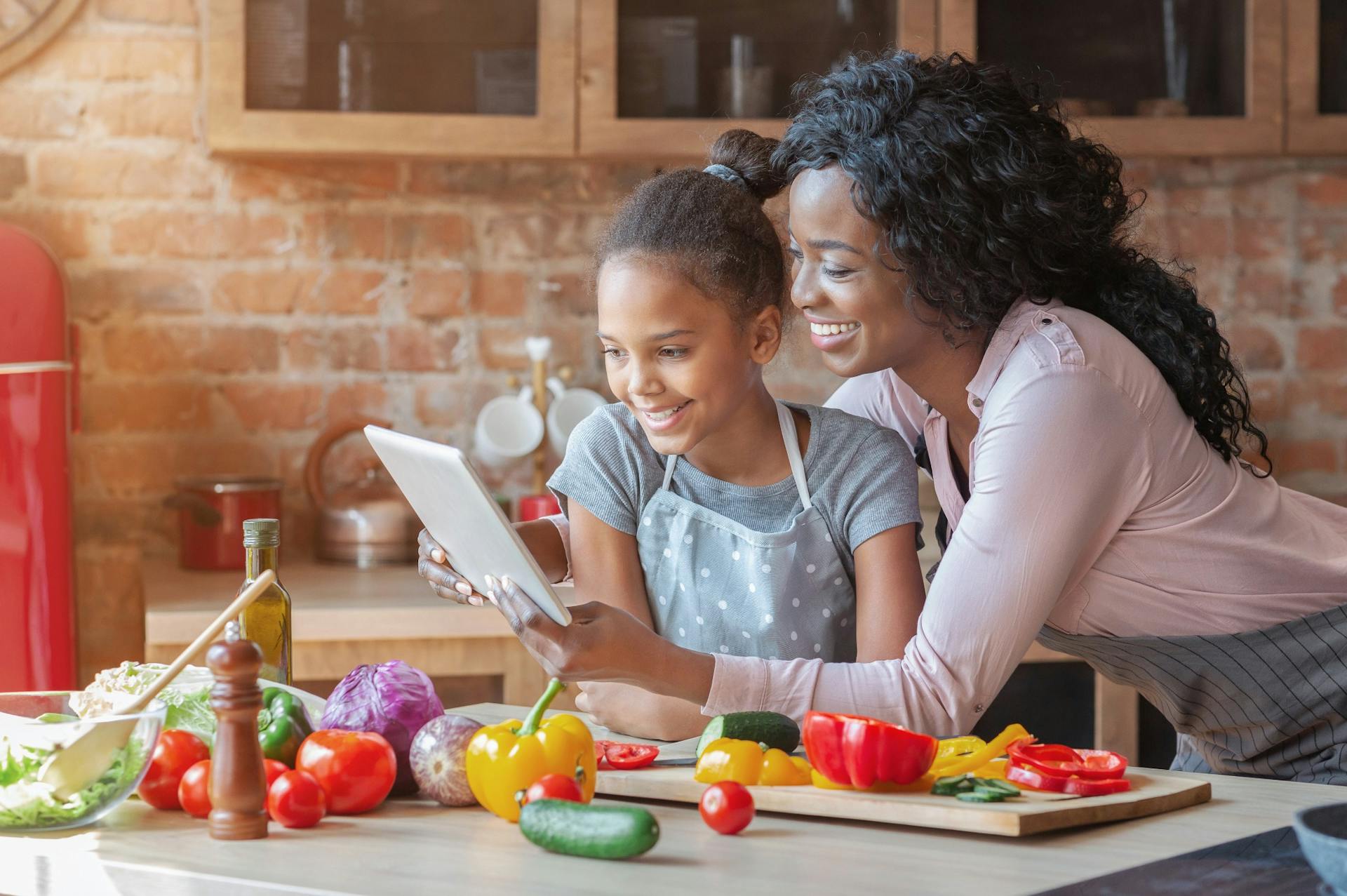 mom and daughter reading a recipe