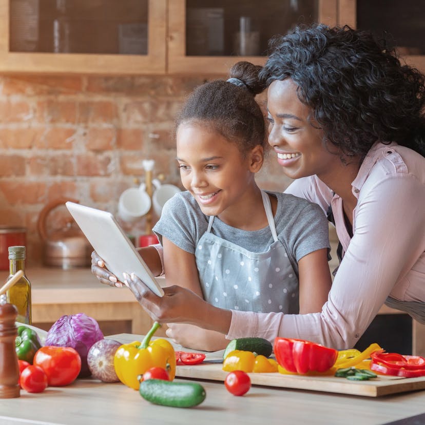 mom and daughter reading a recipe