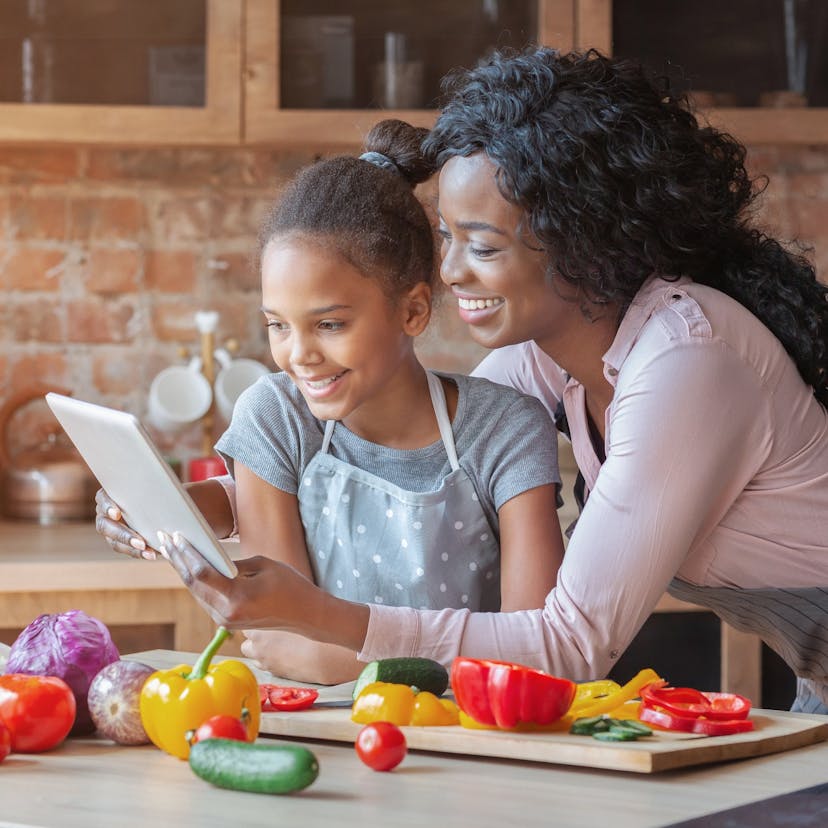 mom and daughter reading a recipe