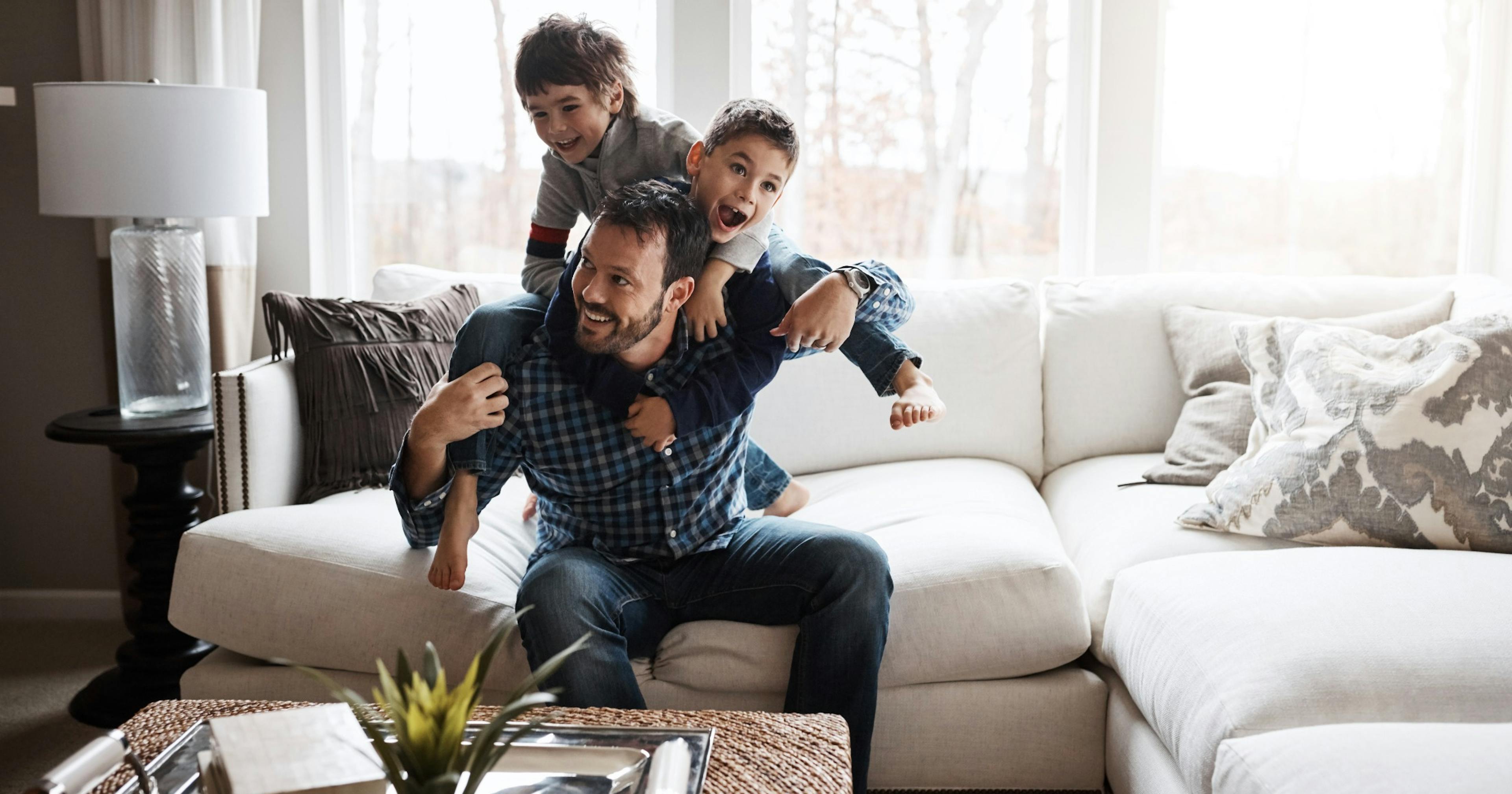 happy kids piling on top of healthy dad