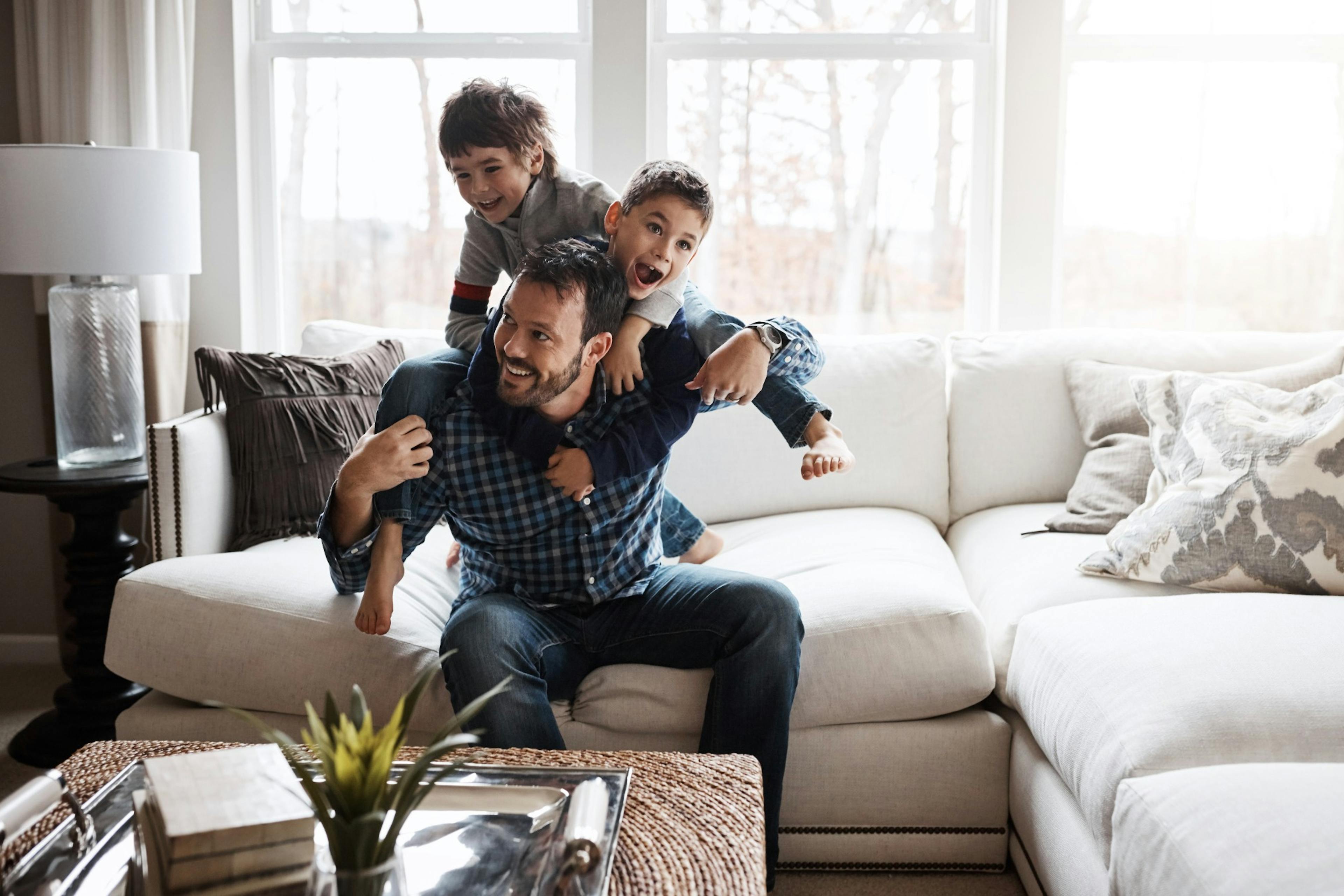 happy kids piling on top of healthy dad