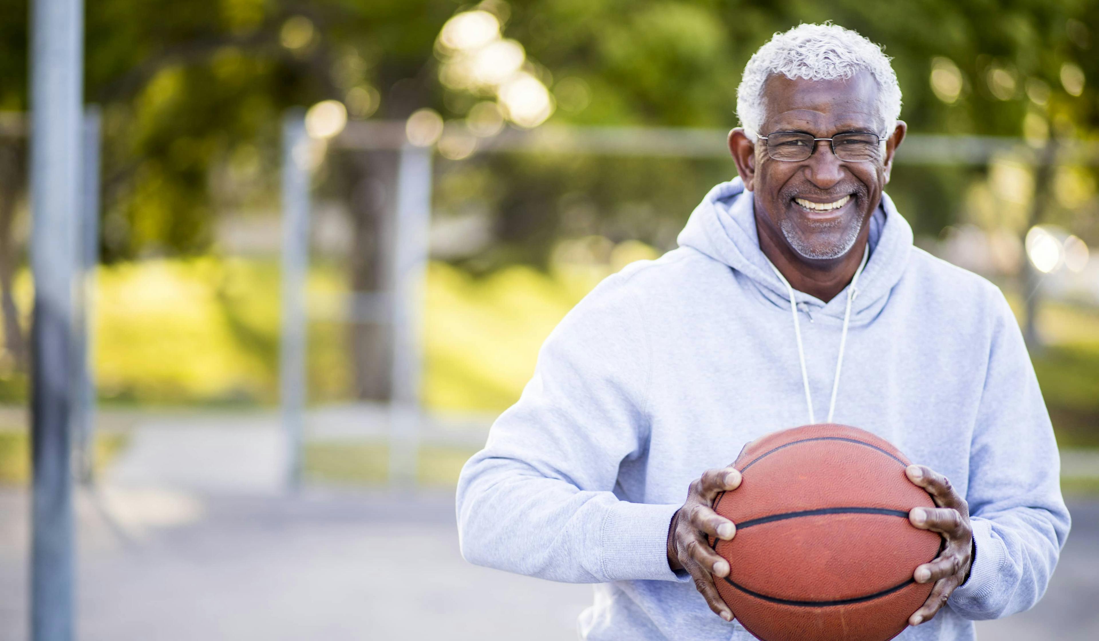 happy man playing basketball