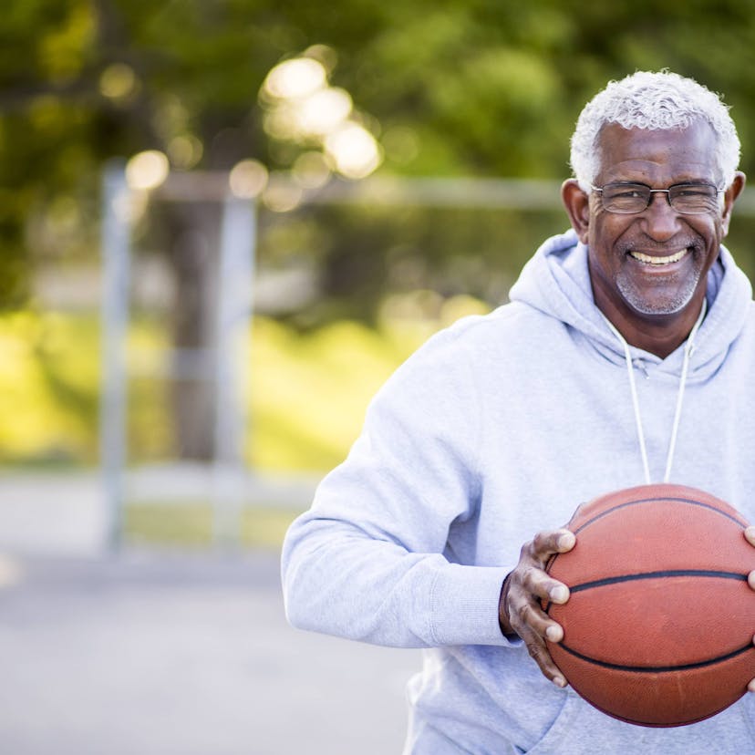 happy man playing basketball