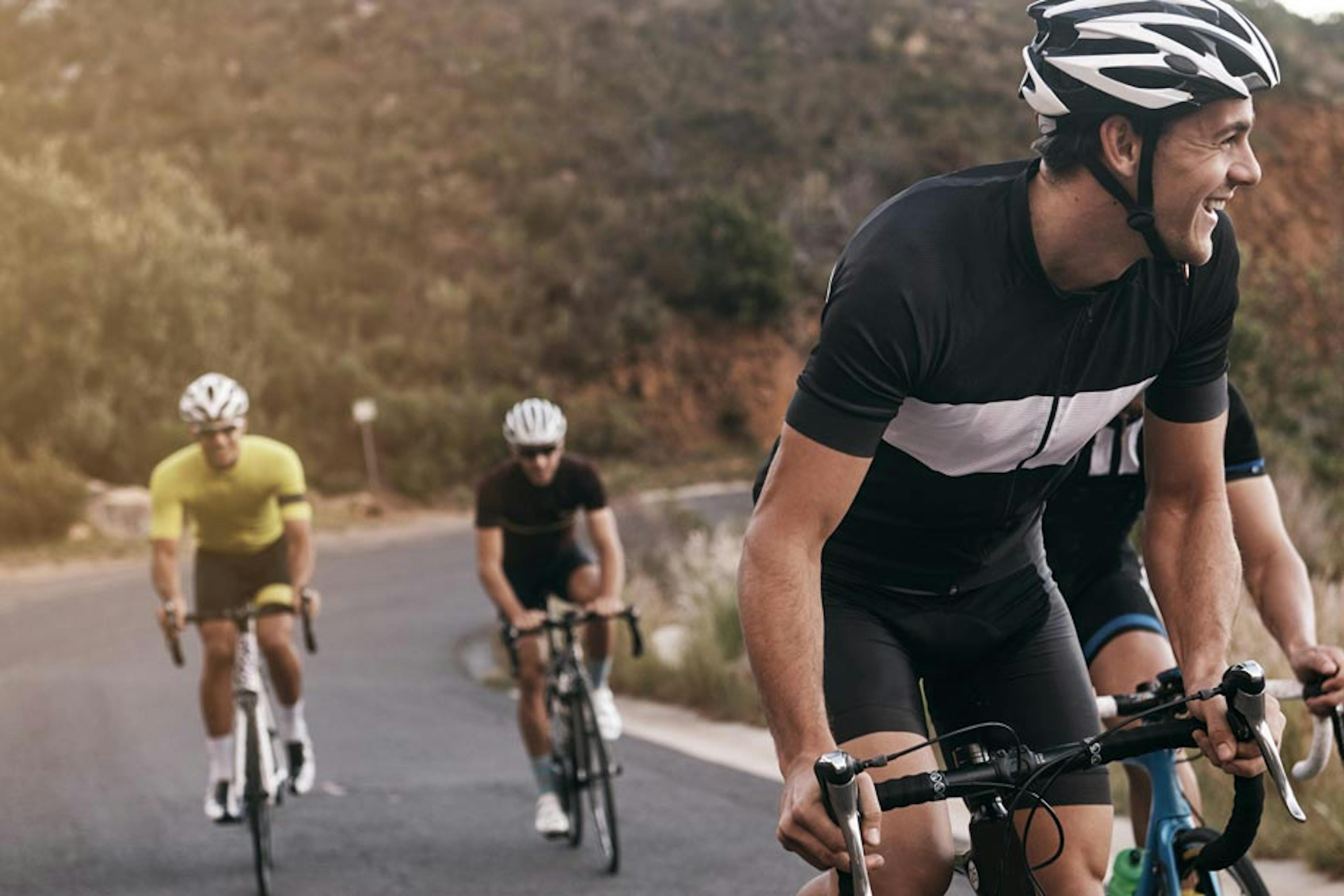 friends cycling together up a hill