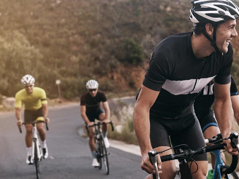 friends cycling together up a hill