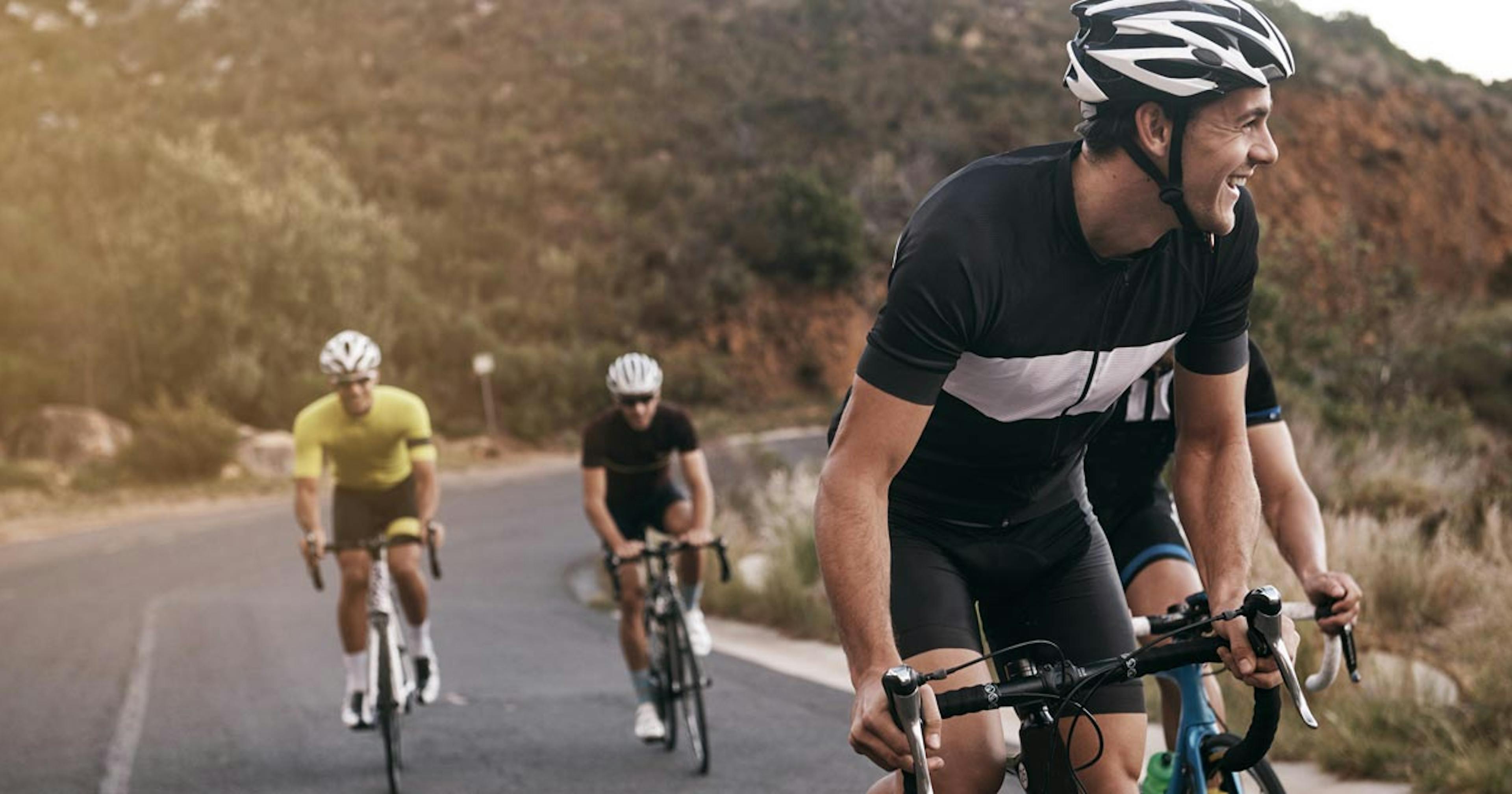 friends cycling together up a hill