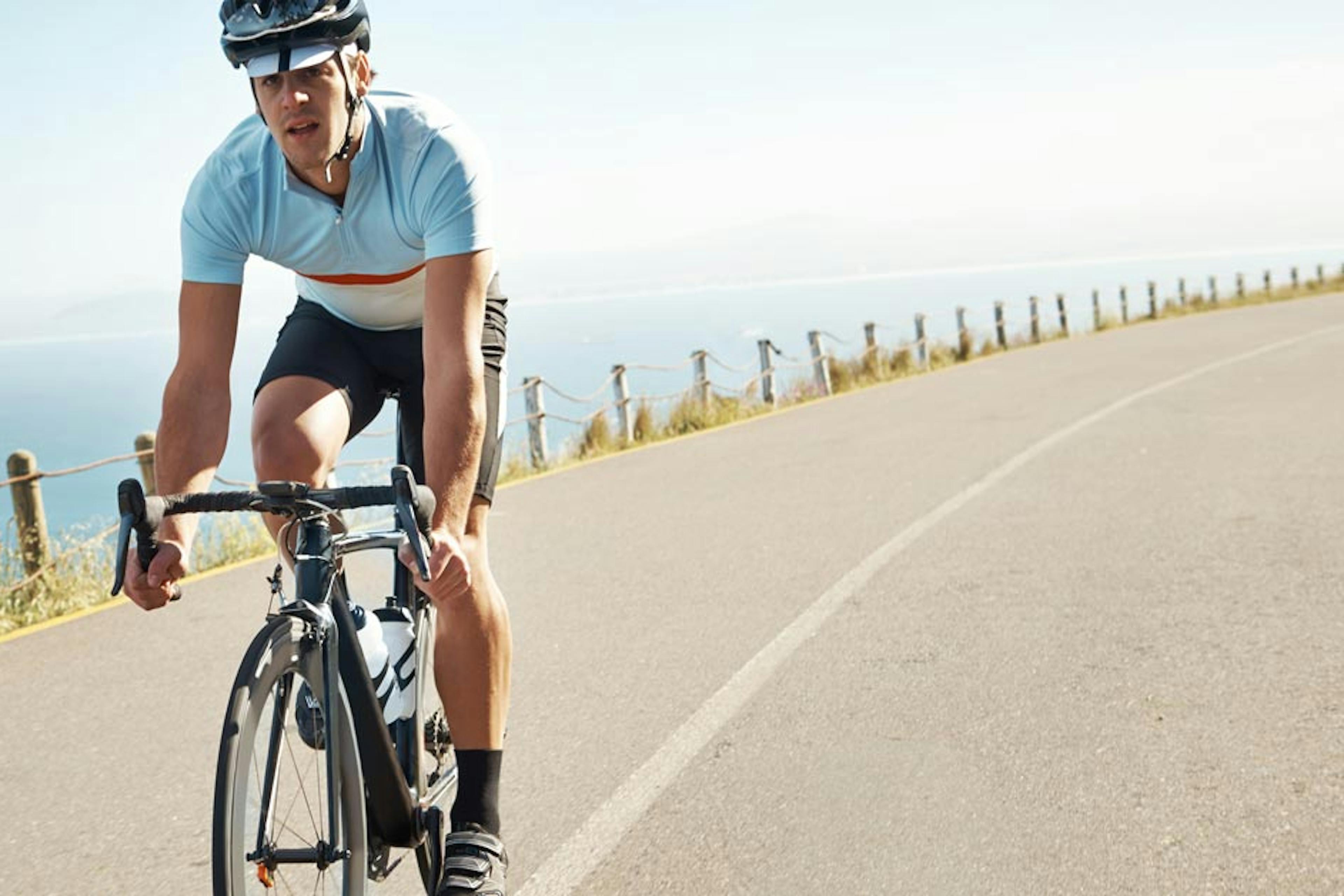 man riding a bike near the coast