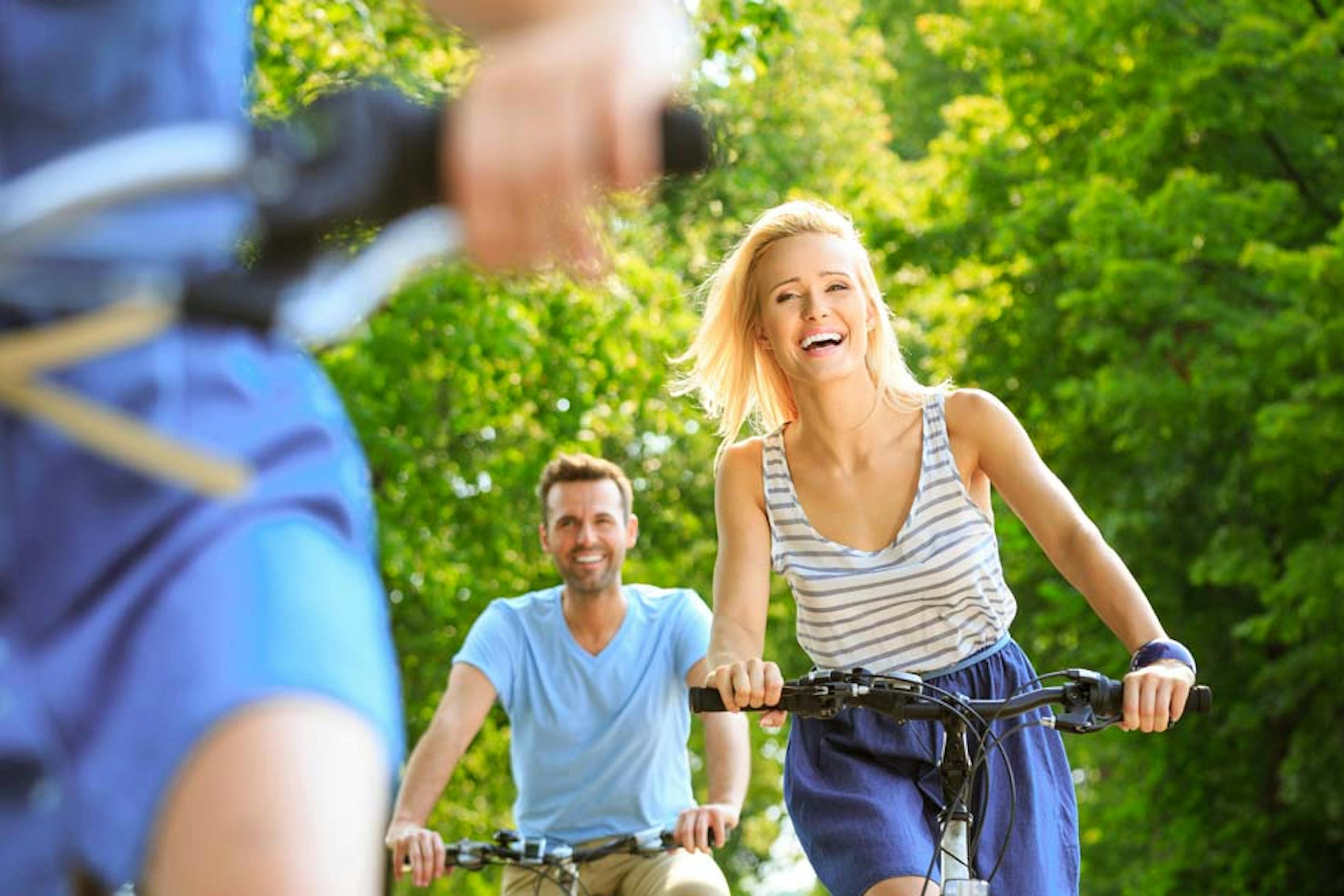 happy woman riding a bike with friends