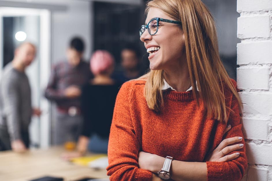 happy businesswoman in an orange sweater