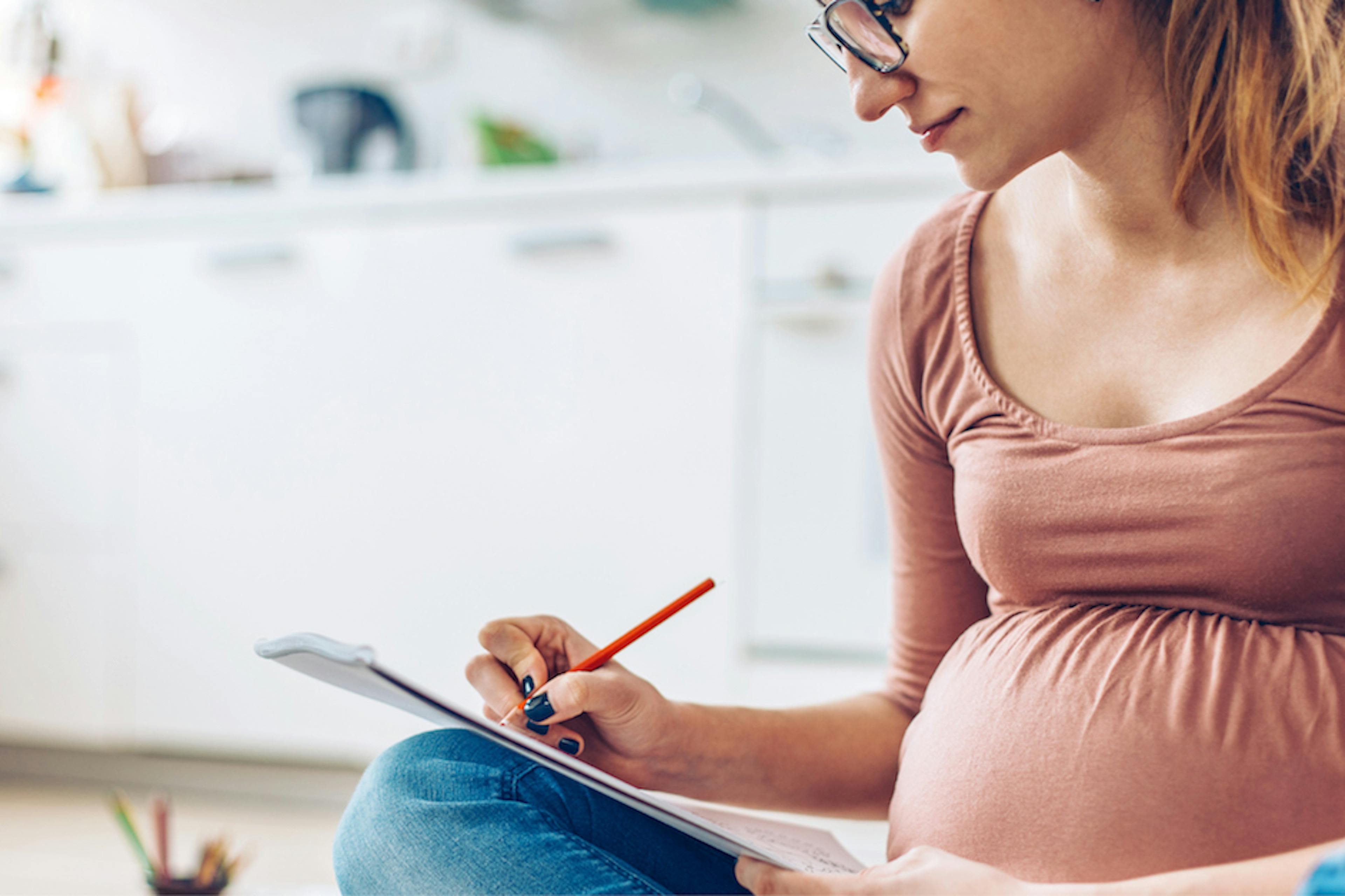 pregnant woman making notes