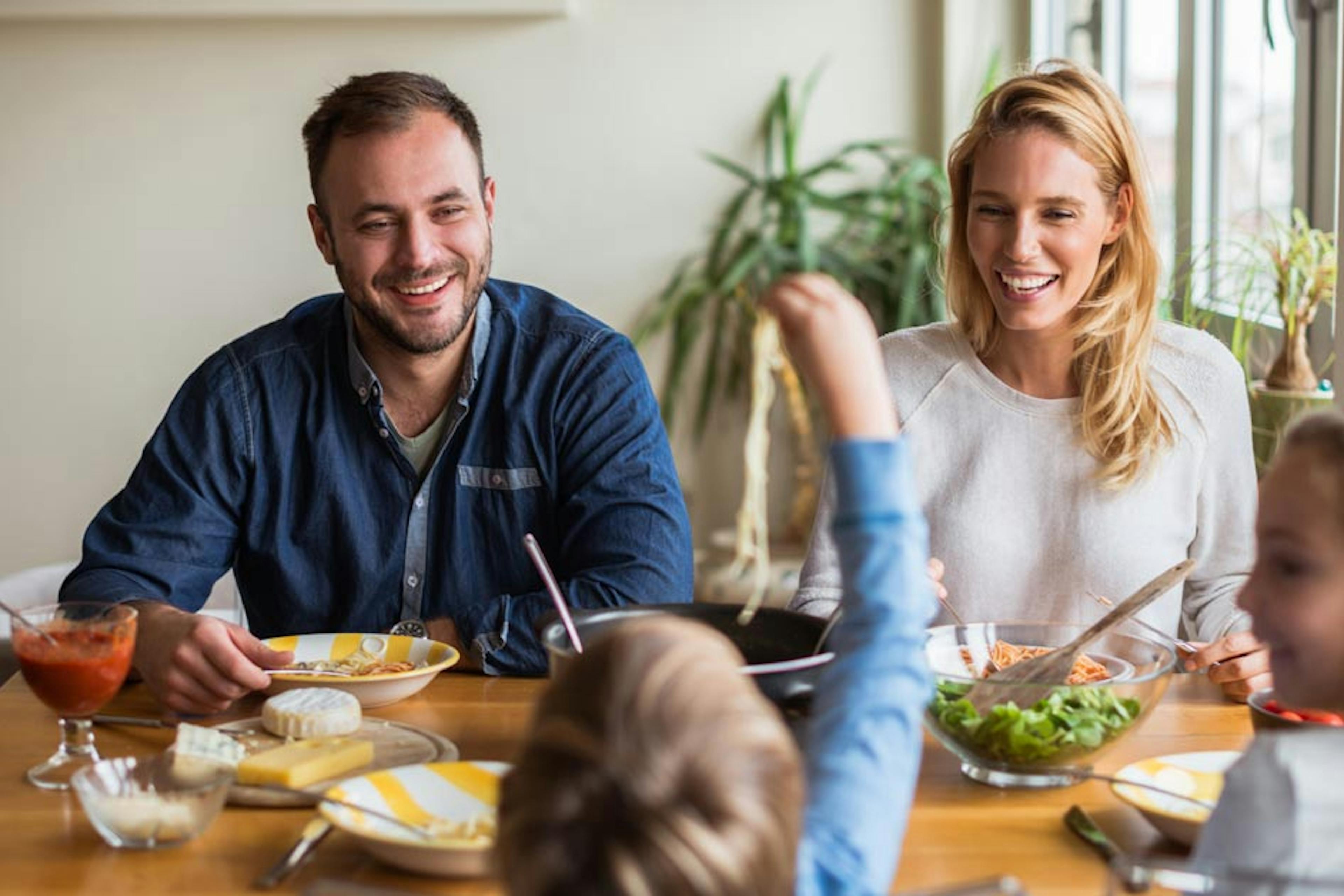 family dinner time with pasta and salad