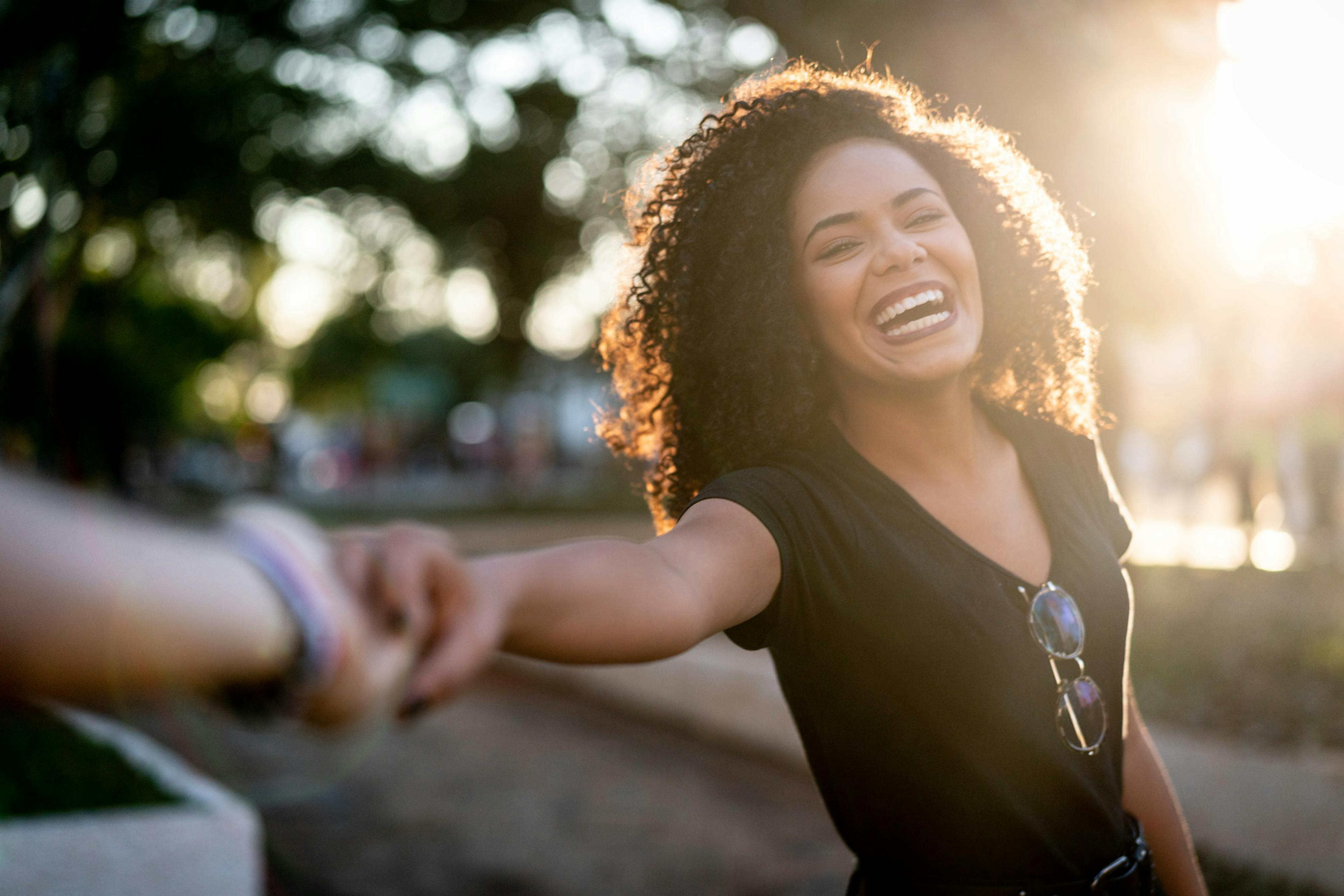 happy woman in the sunshine laughing