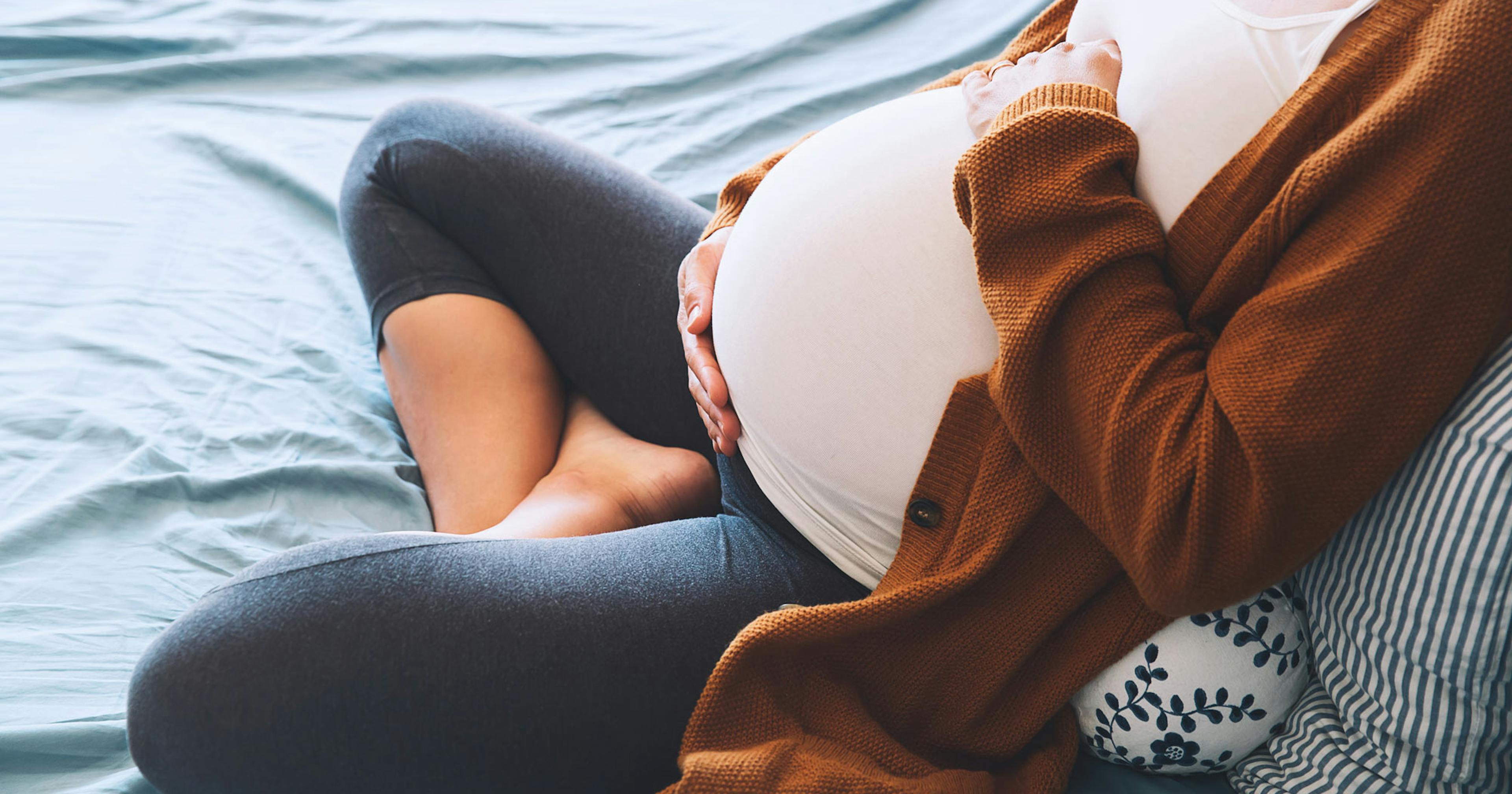 pregnant woman holding her belly