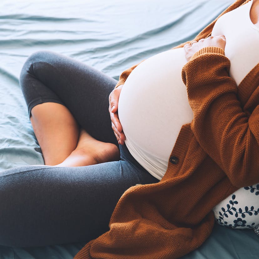 pregnant woman holding her belly