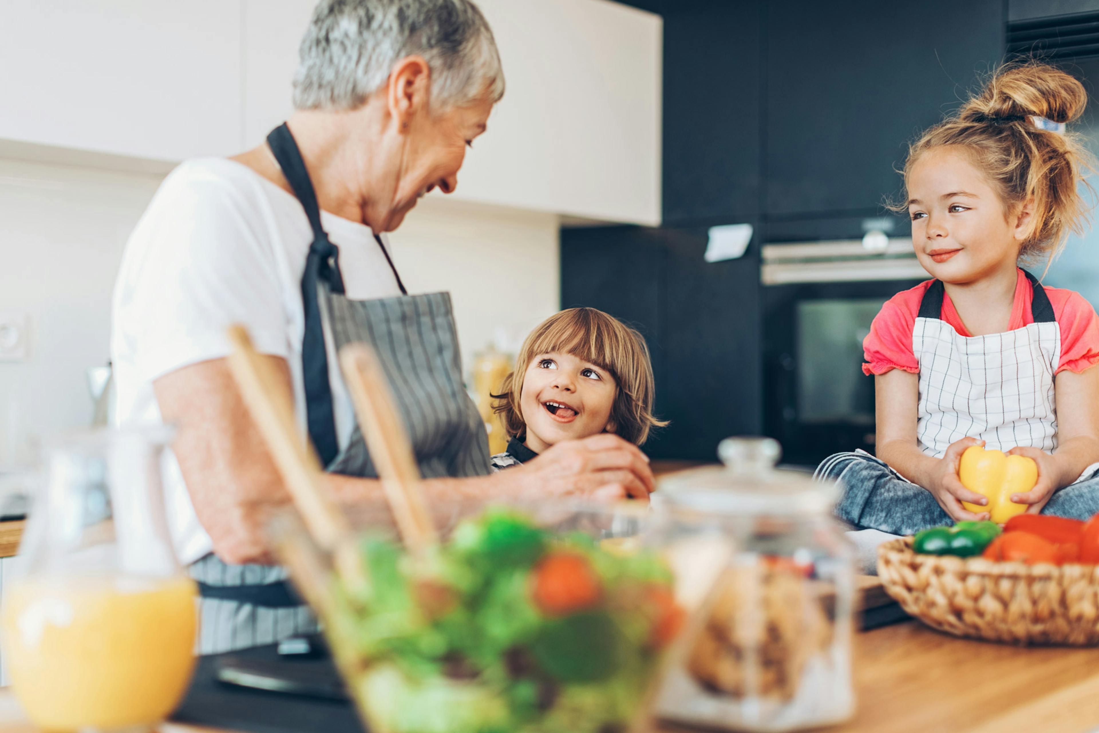 grandma making healthy food with her grandchildren