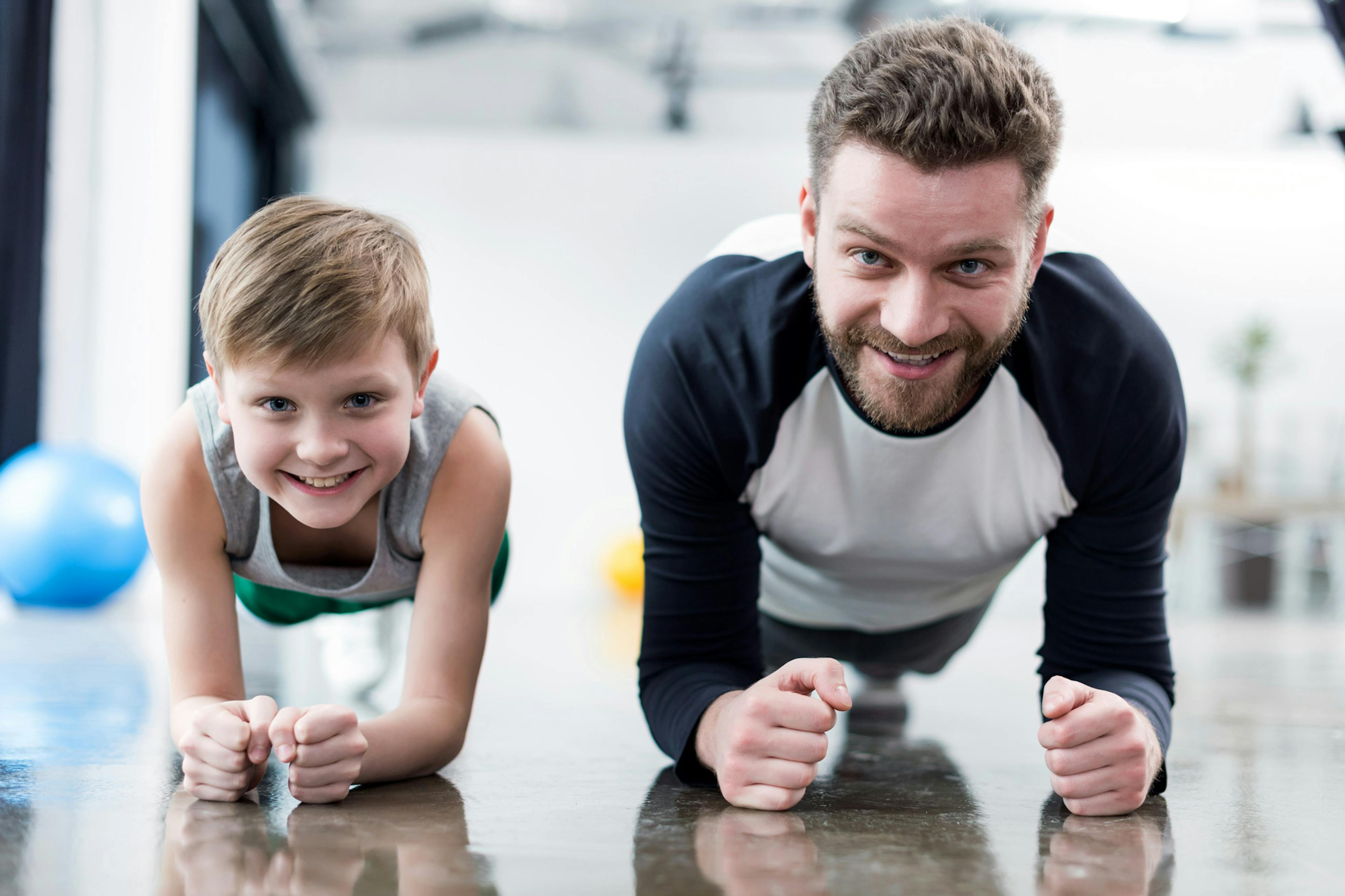 father and son doing planks