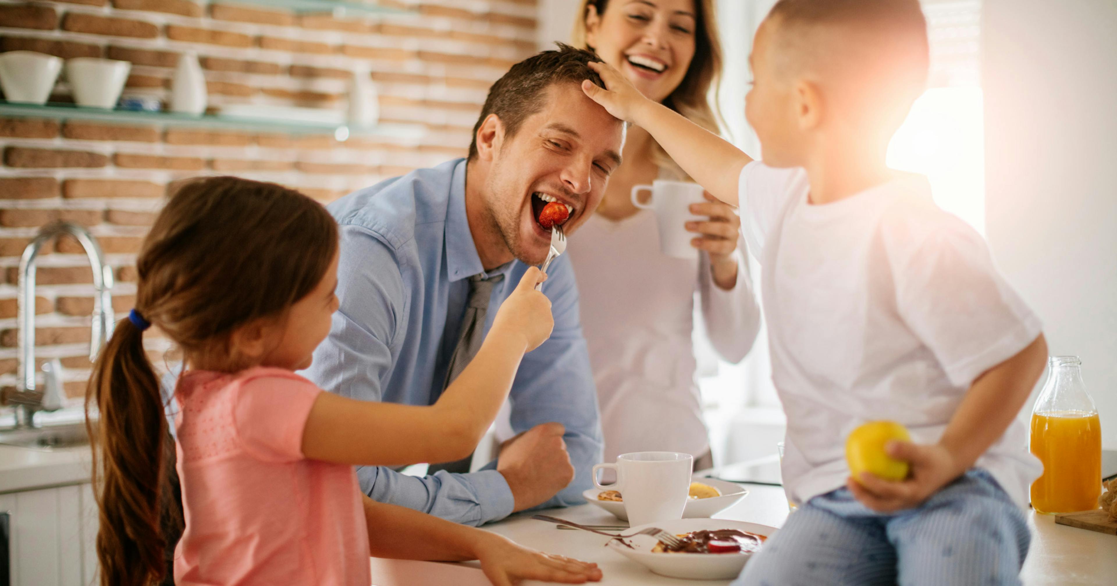 happy family at breakfast, with mom, dad, son and daughter