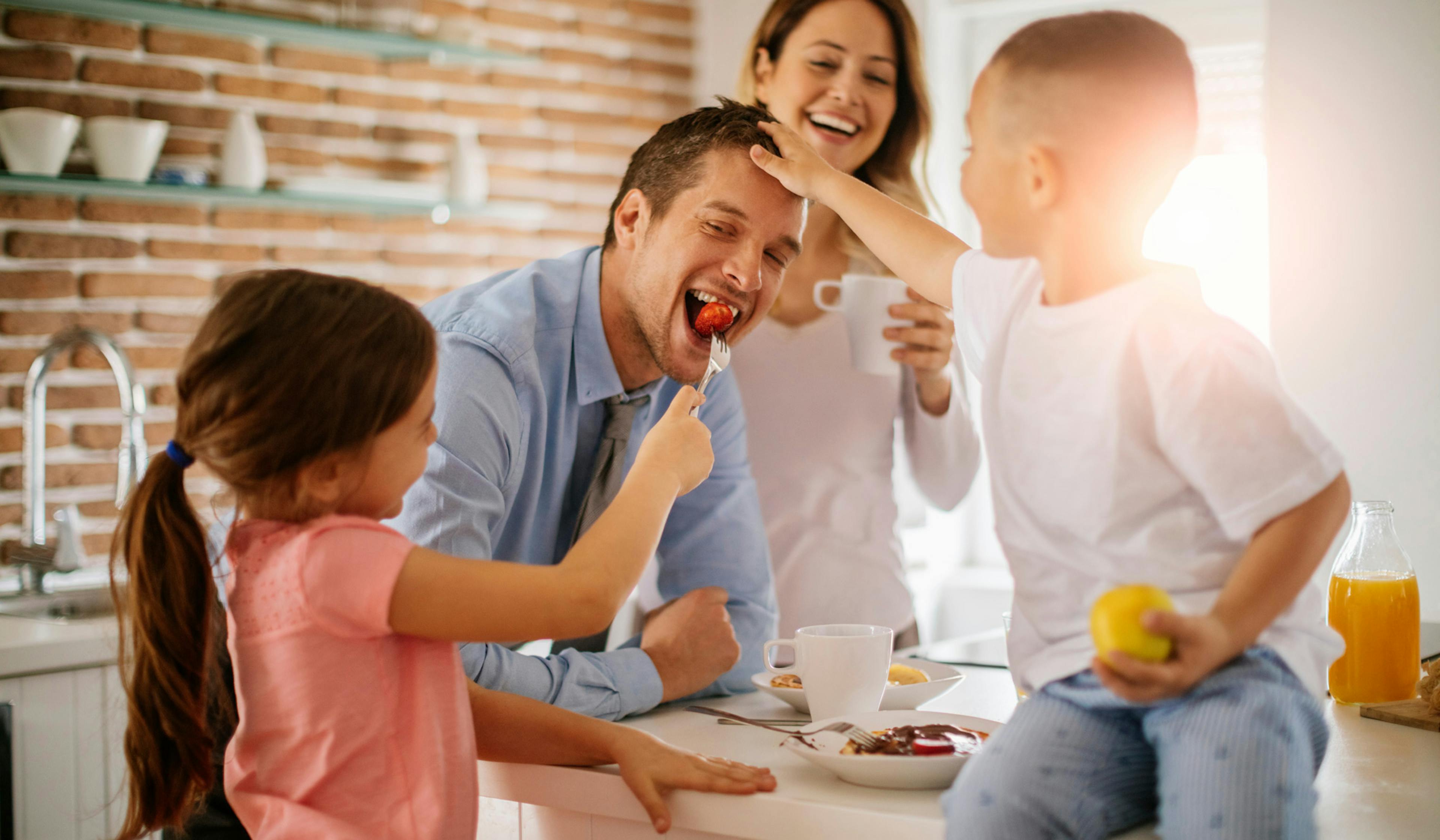 happy family at breakfast, with mom, dad, son and daughter