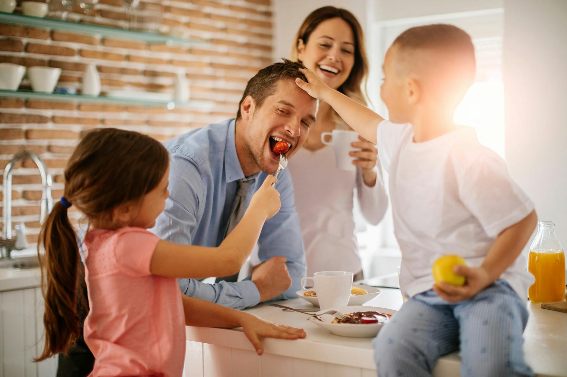 happy family at breakfast, with mom, dad, son and daughter