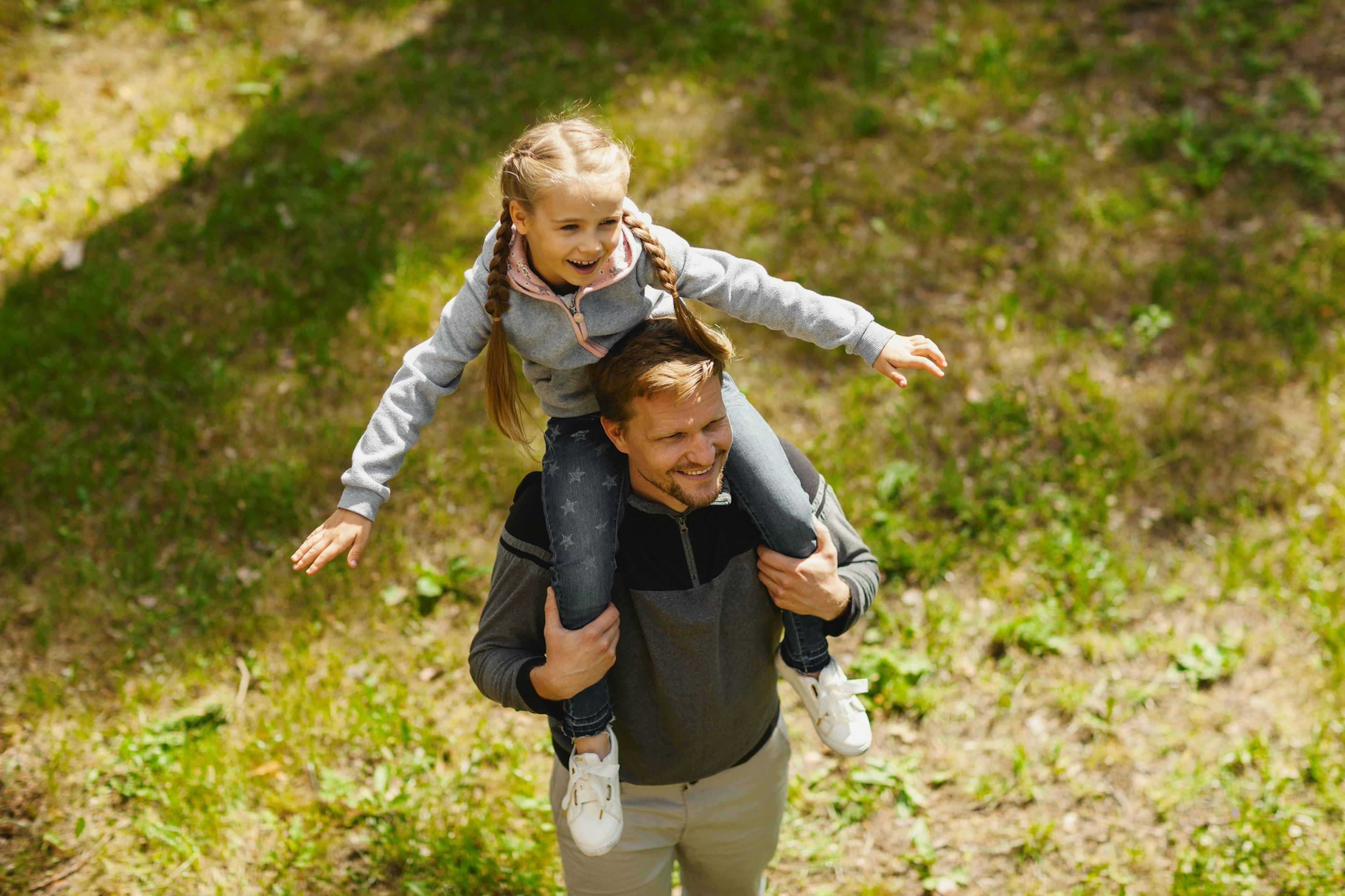 middle age dad giving daughter a piggyback ride