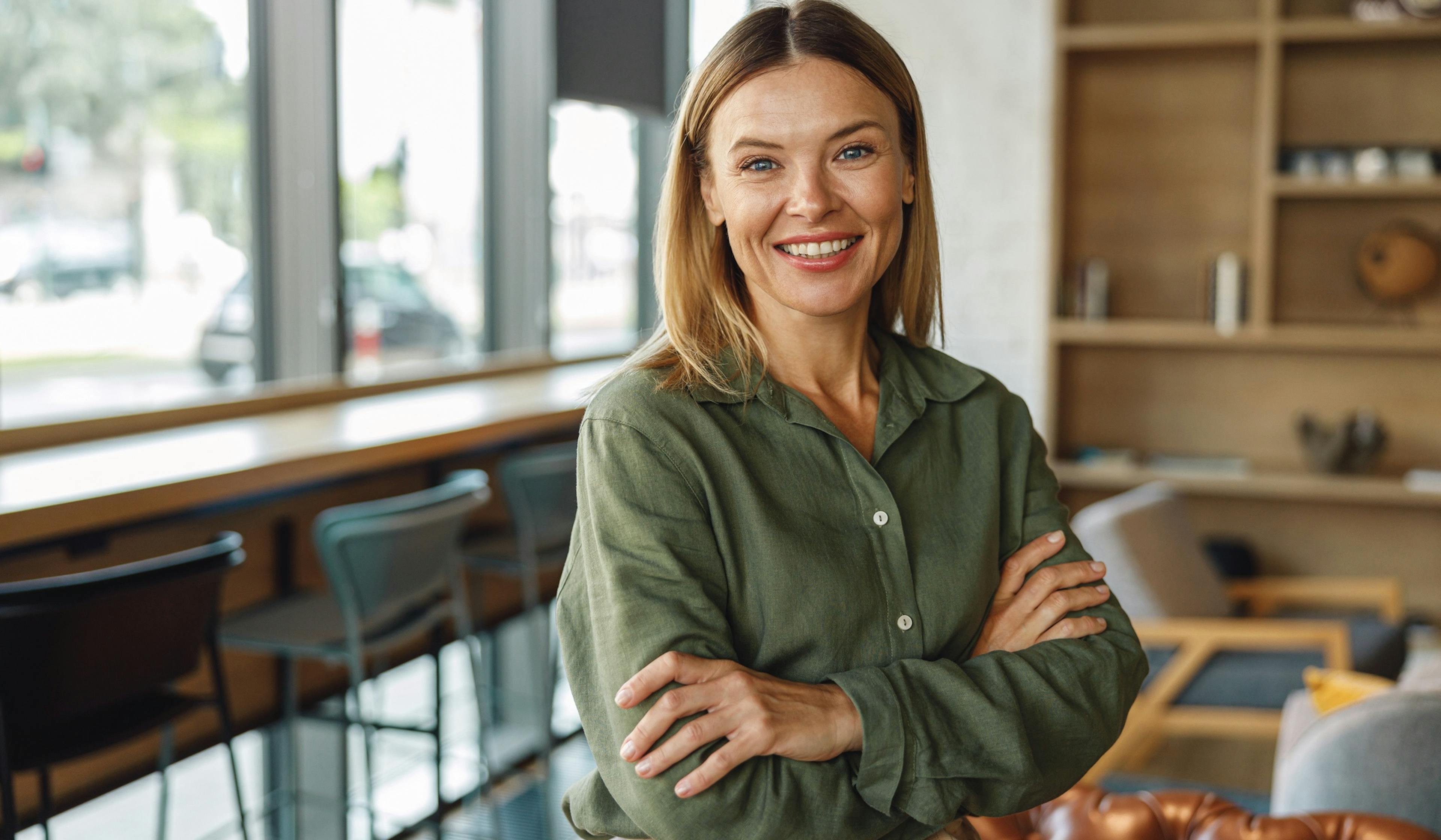 happy woman standing in an office lounge