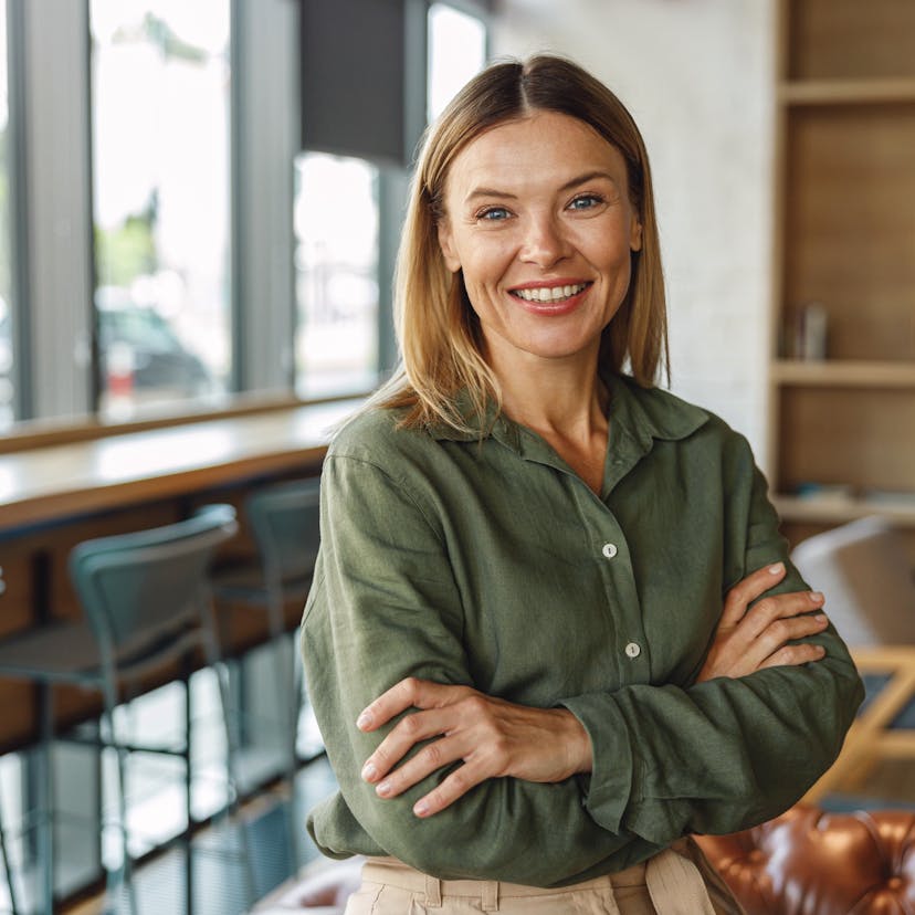 happy woman standing in an office lounge