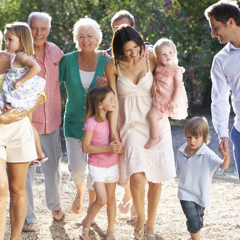 multi generational happy family walking in the sunshine