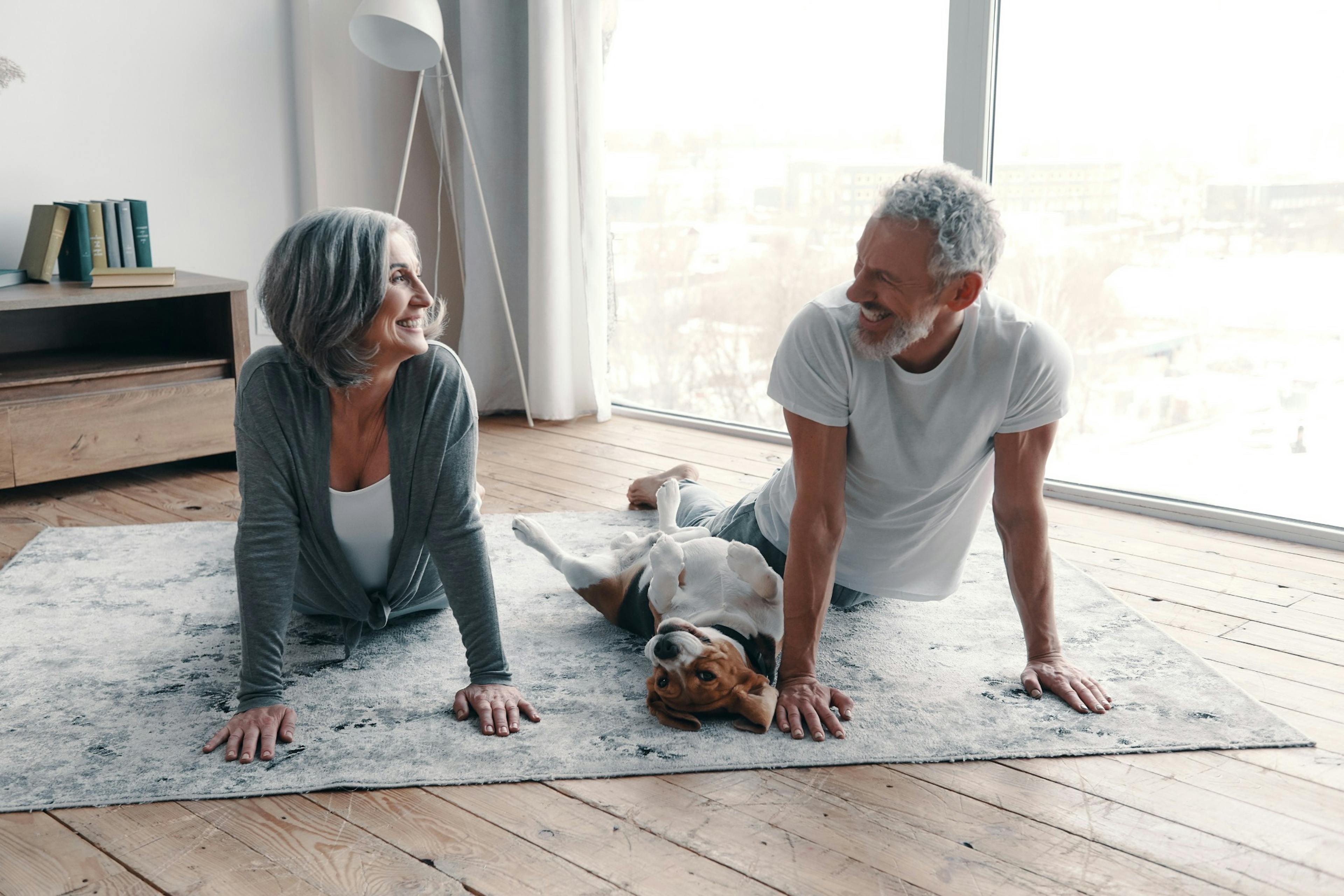 loving middle age couple doing yoga