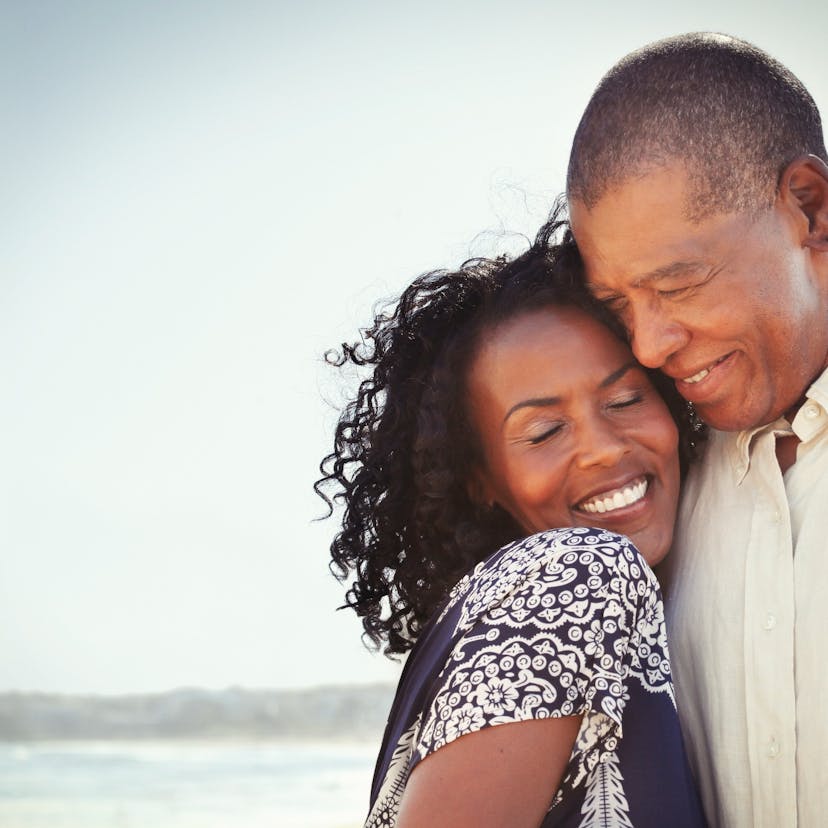 happy couple embracing on the beach.