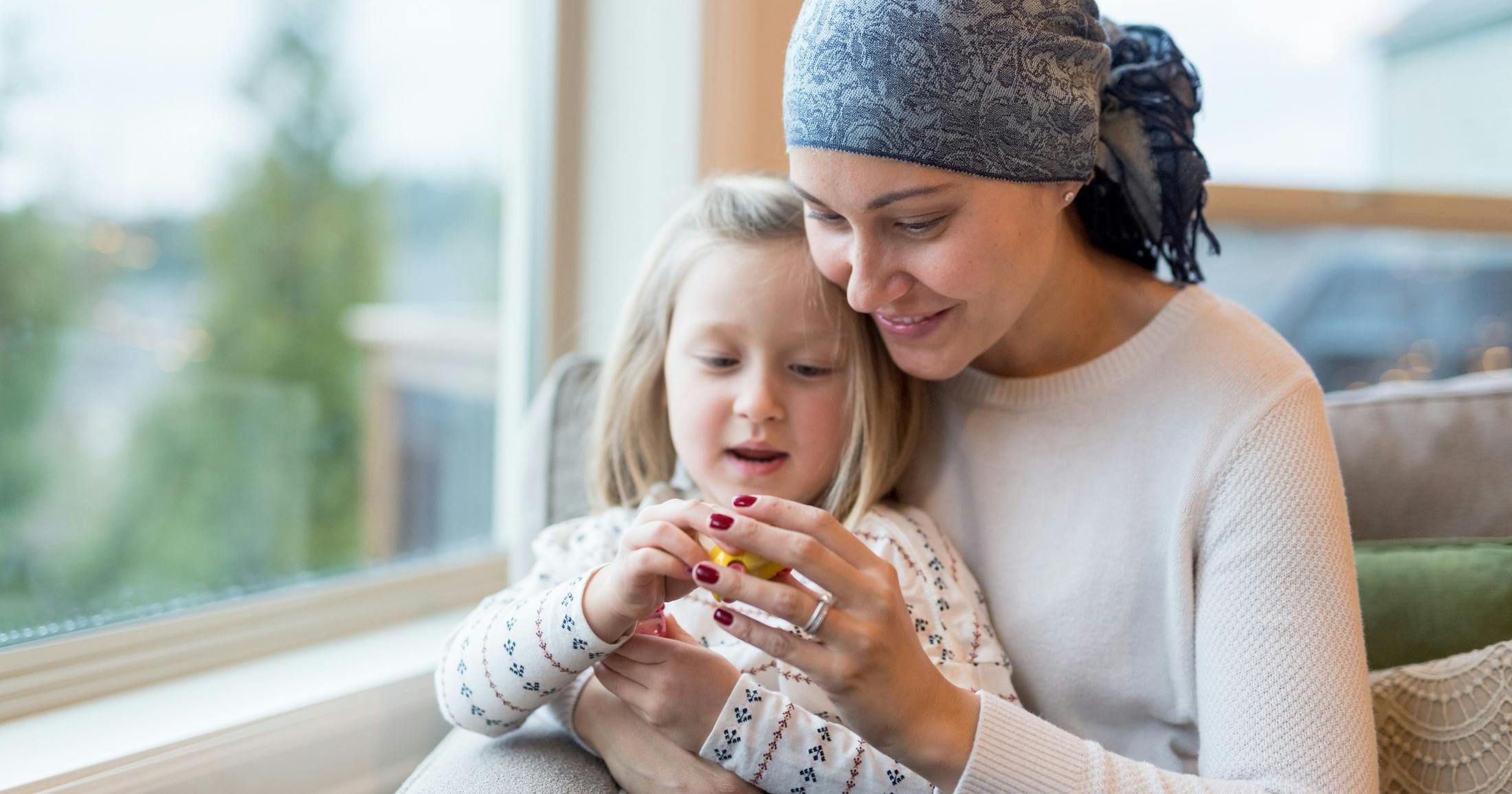 young mom with cancer holds daughter