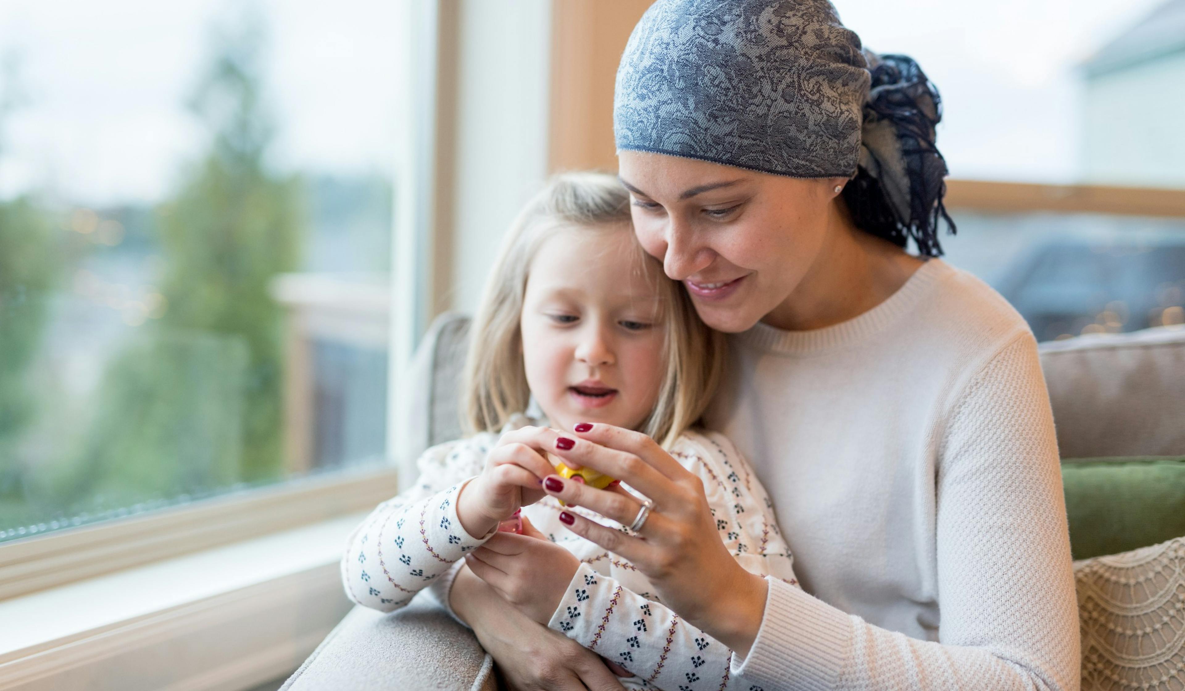 young mom with cancer holds daughter