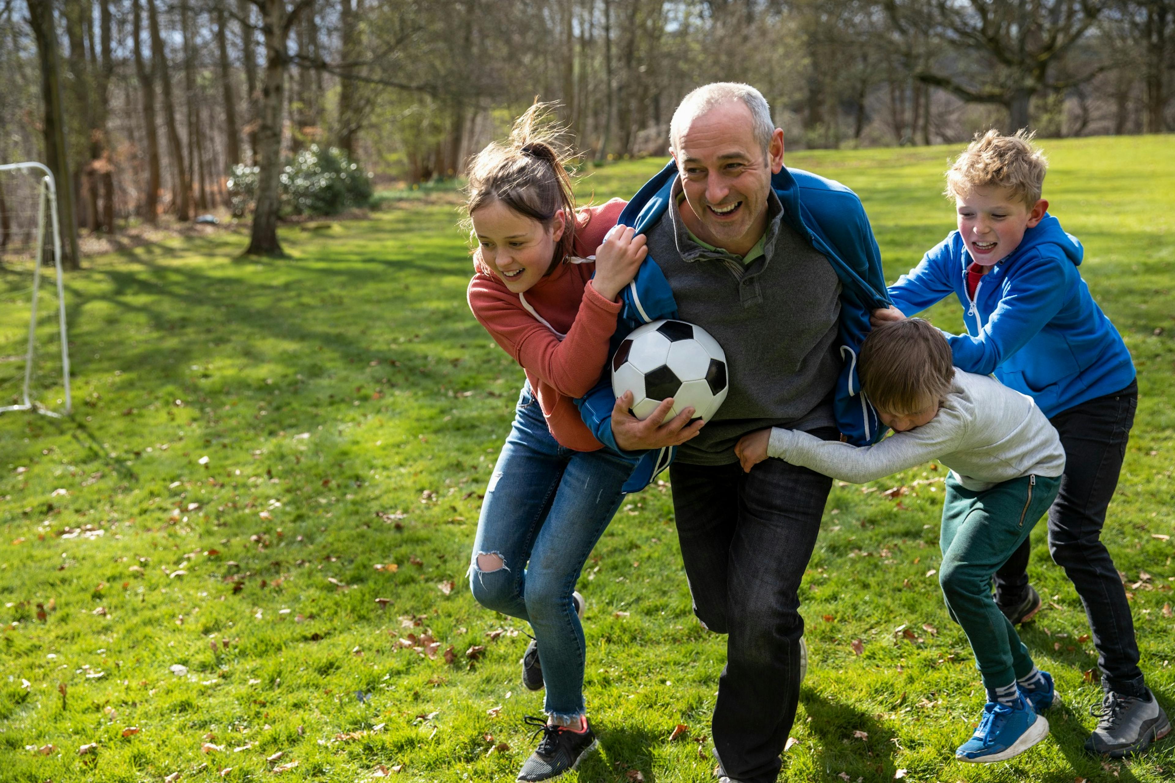 happy middle age man playing with kids