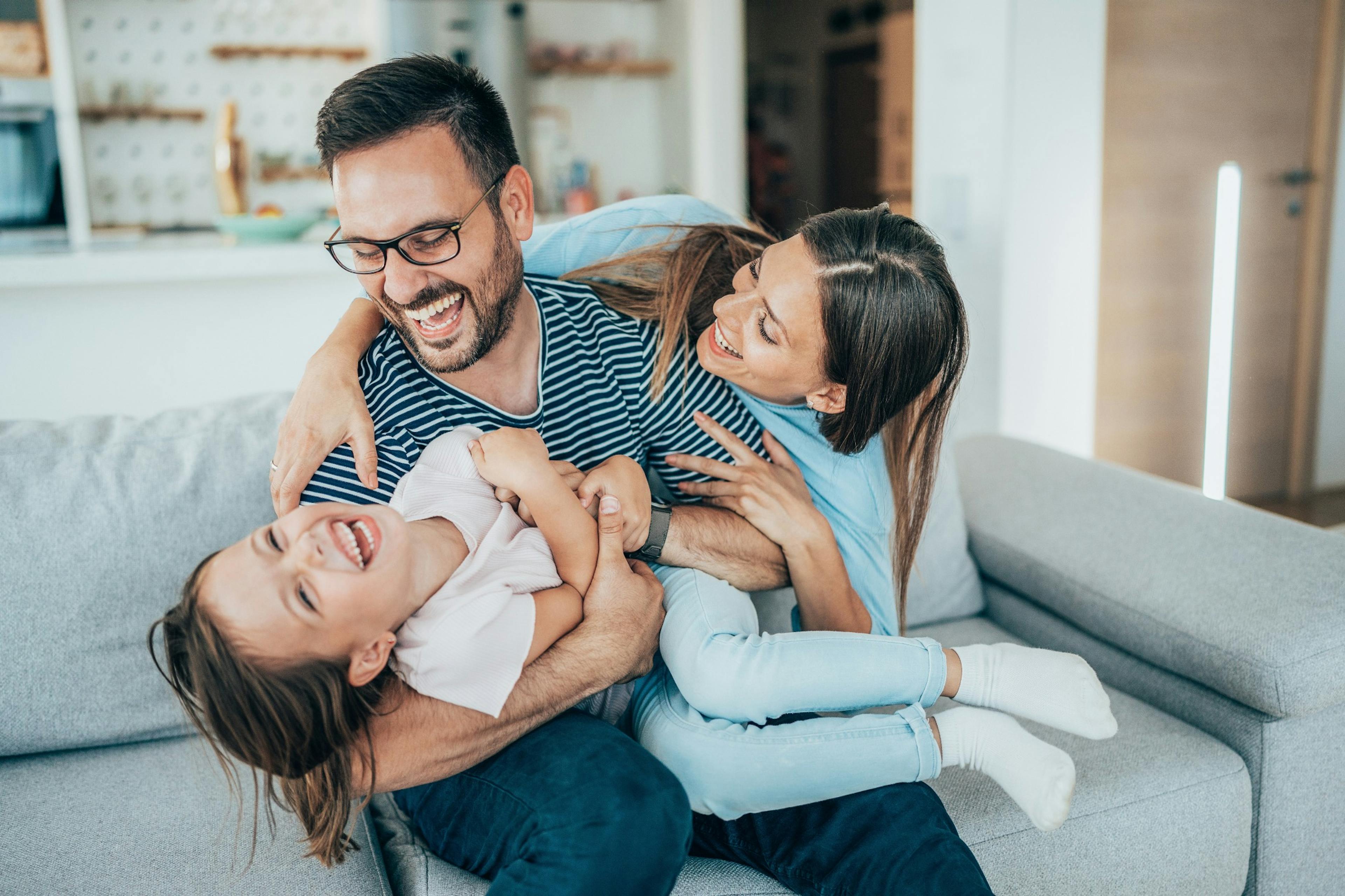 happy healthy dad with wife and daughter